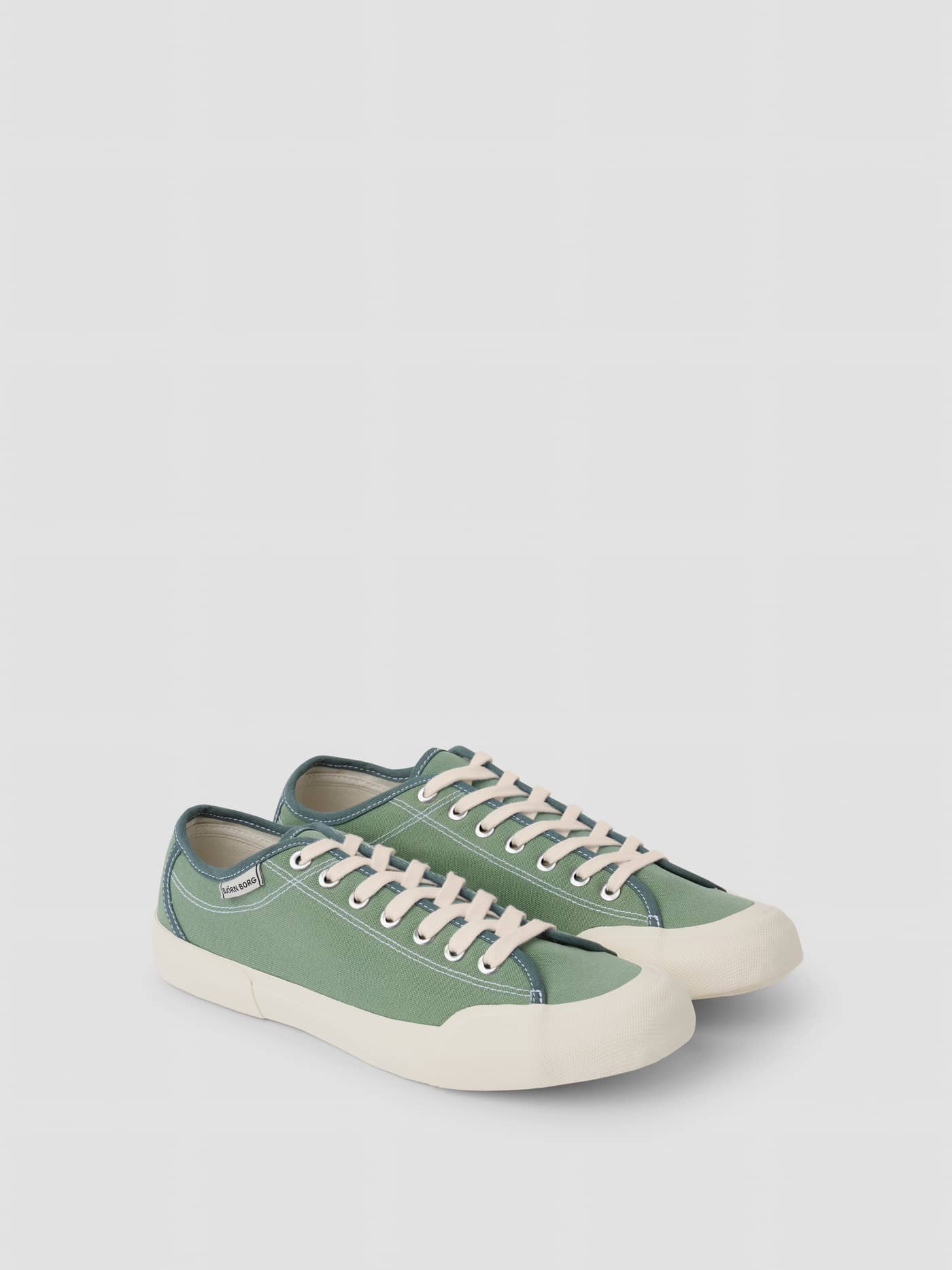 Side view of the green Unisex Smash Sneakers, crafted from cotton canvas with a classic tennis-inspired design. - Image 2