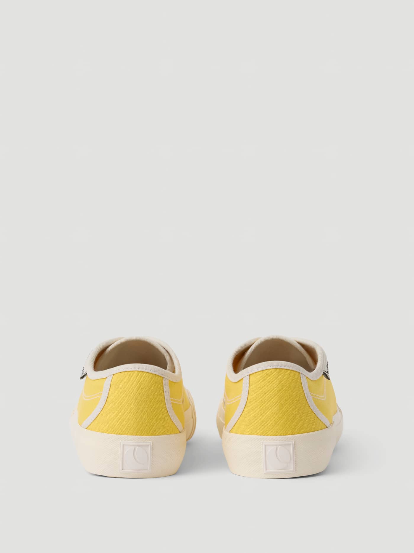 Rear view of the yellow Unisex Smash Sneakers, featuring breathable cotton canvas and a tonal logo for tennis style. - Image 3