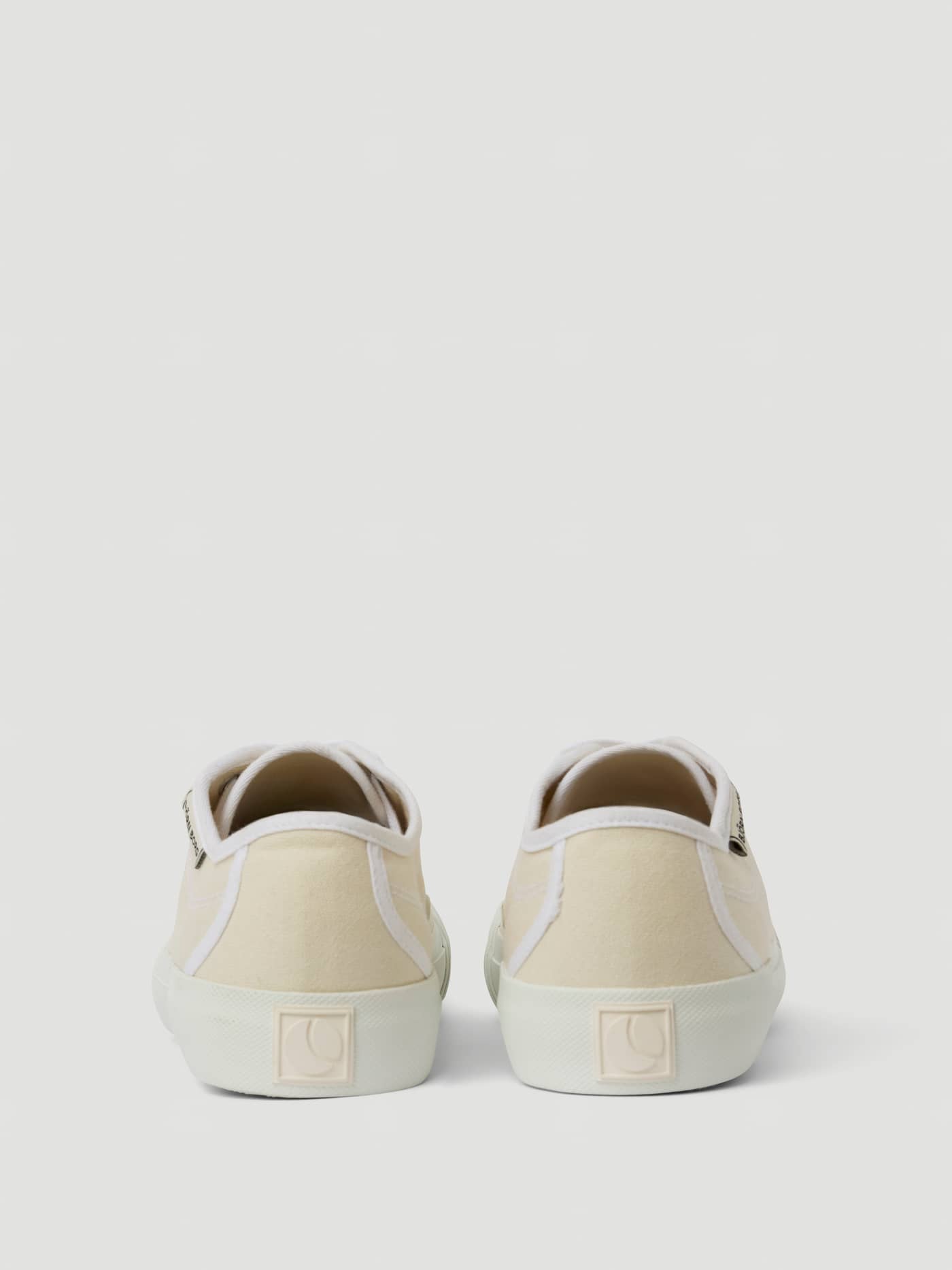Back view of the beige Unisex Smash Sneakers featuring a breathable cotton canvas and a tennis-inspired design. - Image 3