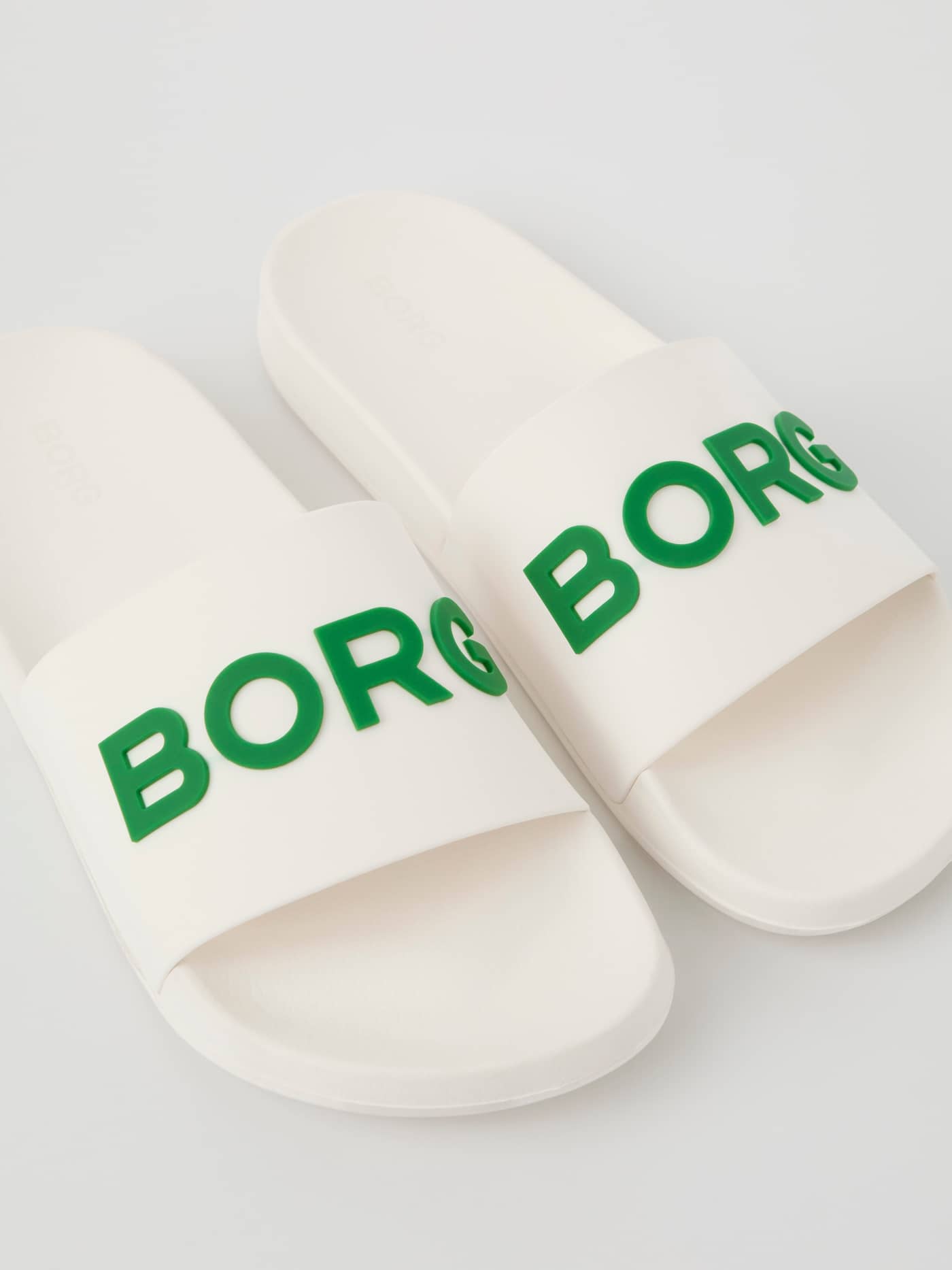 Unisex Knox Slides in white and green, featuring durable TPU construction and a bold green BORG logo across the strap. - Image 2