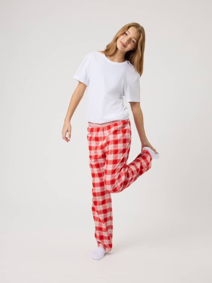 Front view of a girl in Björn Borg Core Flannel Pyjama Pants for kids in Small Tartan 4 (Pink, Red, White) checked flannel.