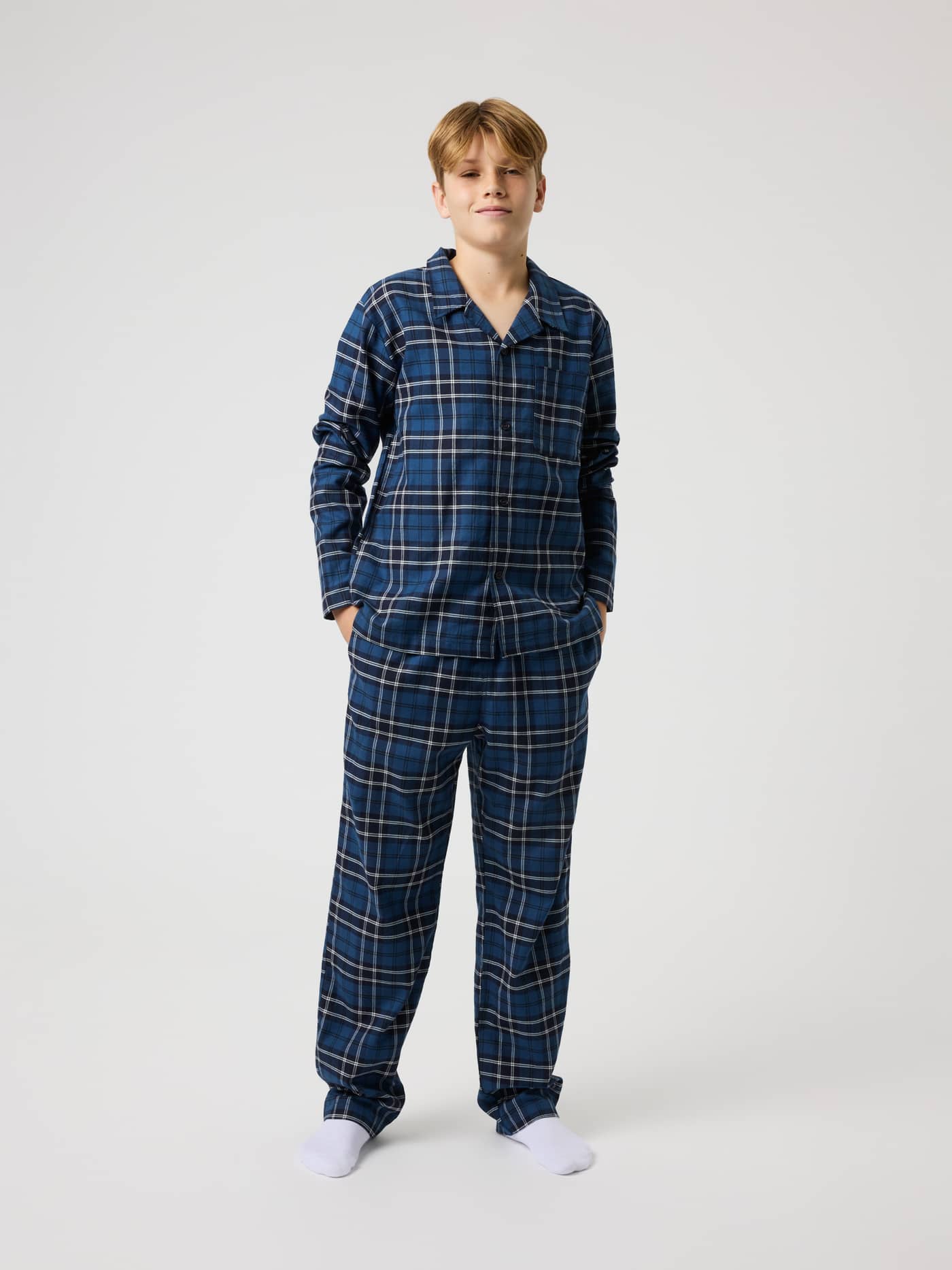Full-body front view of a kid wearing Björn Borg Core Flannel Pyjama Pants in Forest Tartan 4 (Green) with a tartan pattern. - Image 4