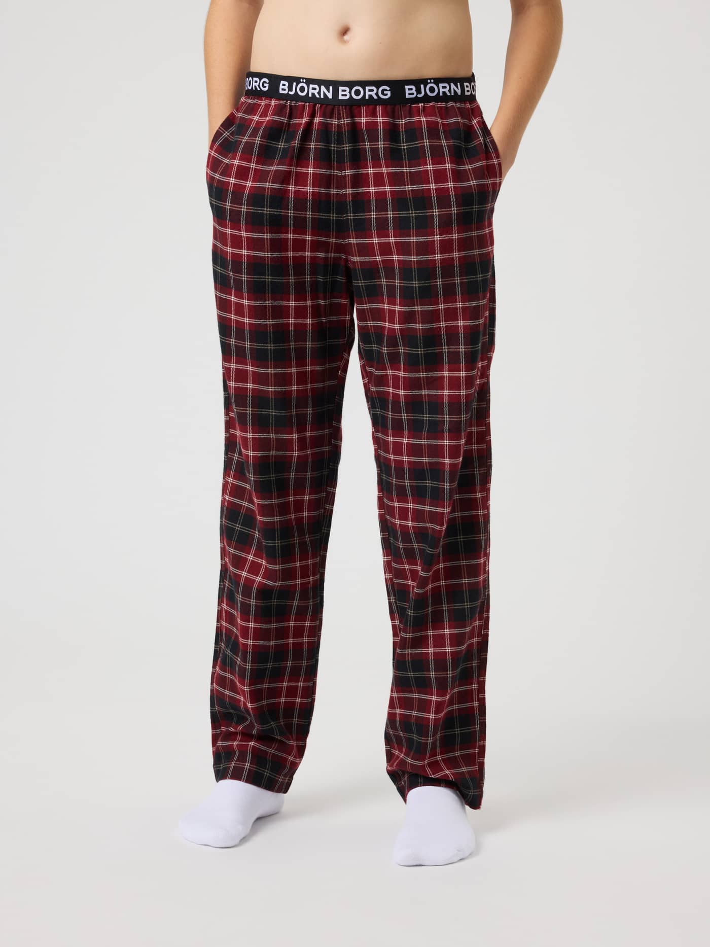 Core Flannel Pyjama Pants for kids in a red and black tartan pattern featuring a white logo on the waistband. - Image 2