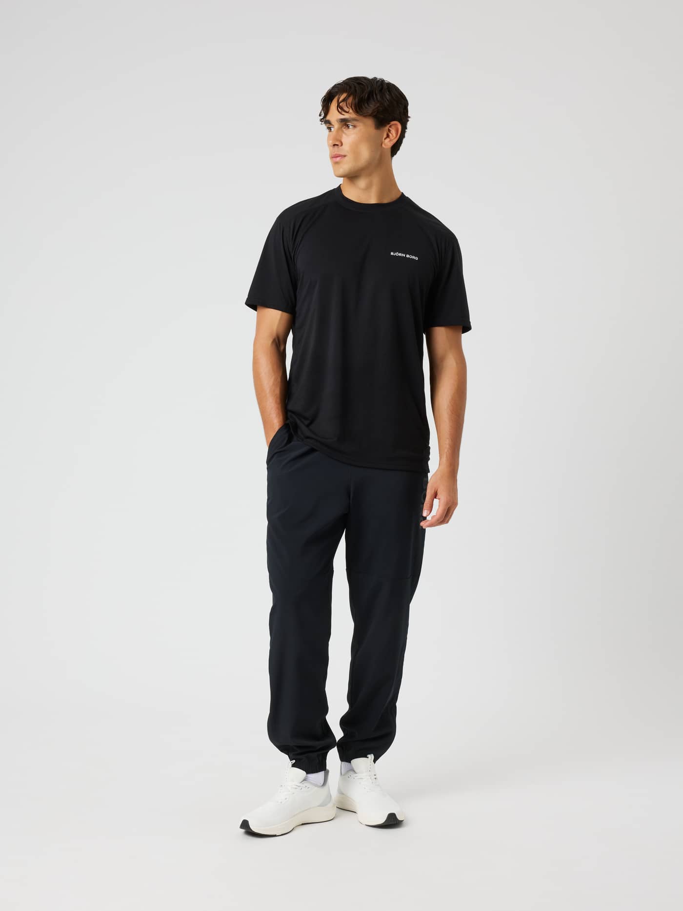 Full-body front view of a model wearing Borg Training Pants in Black Beauty (Black) for high-performance training. - Image 3