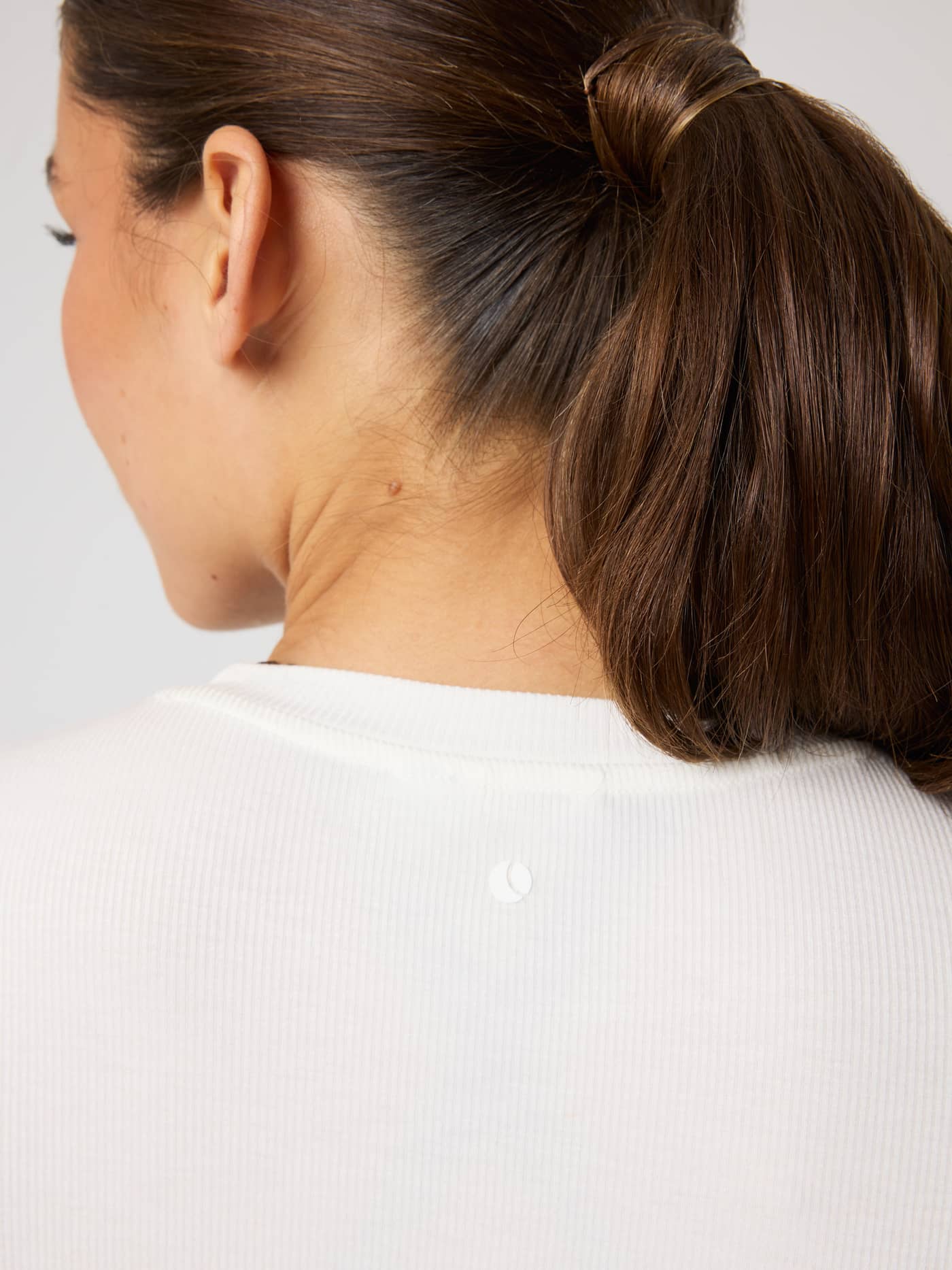 Studio Ribbed Cropped Long Sleeve in Tofu (White) for training, featuring a ribbed texture and white tennis ball logo. - Image 5