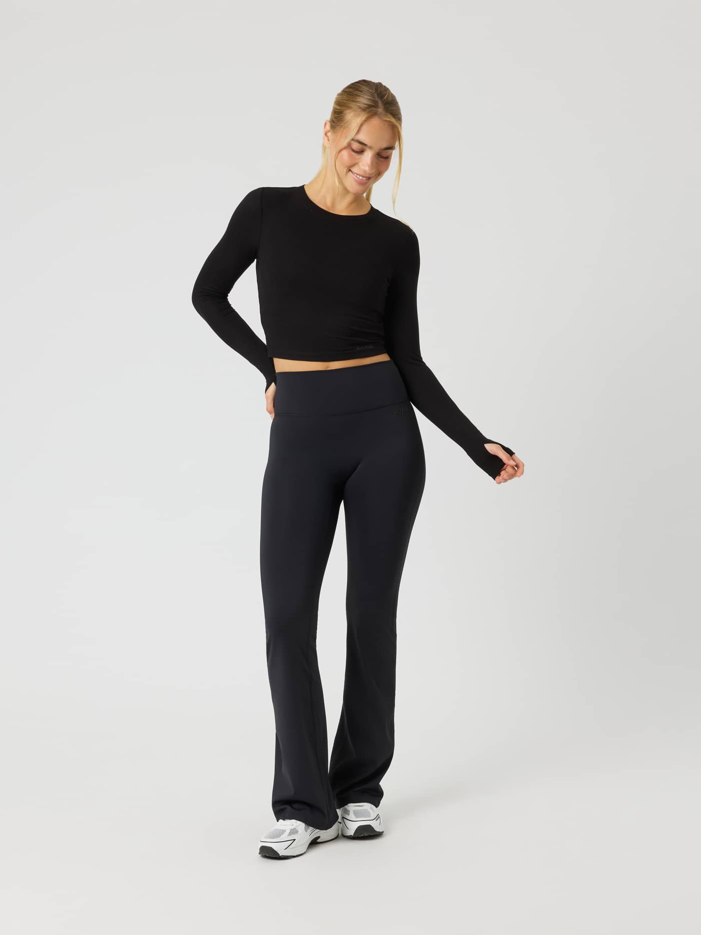 Full-body front view of a model wearing the Studio Ribbed Cropped Long Sleeve in Black Beauty (Black) for training. - Image 3