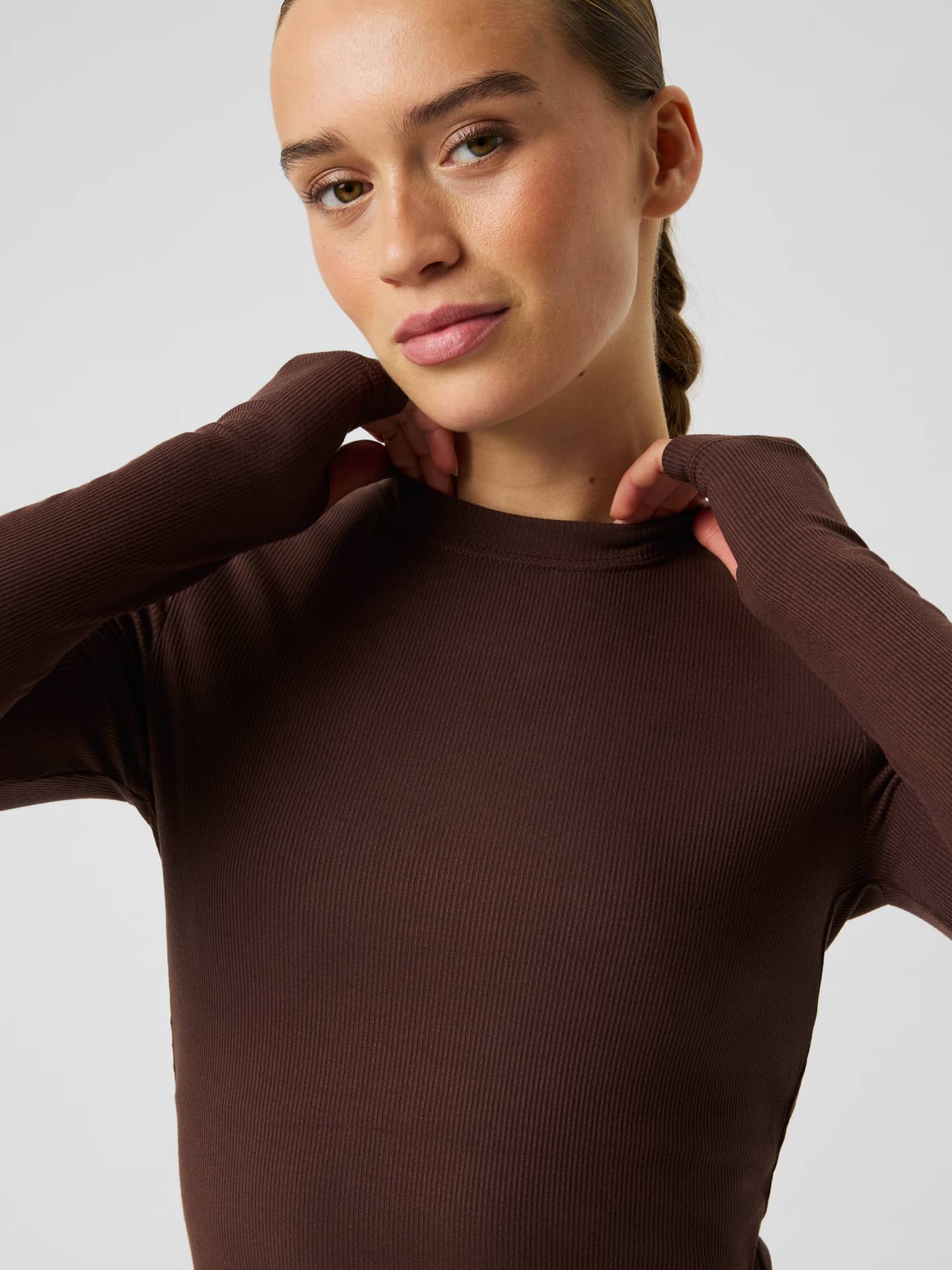 Studio Ribbed Cropped Long Sleeve in Coffee Bean (Brown), a technical ribbed training top with functional thumb holes. - Image 4