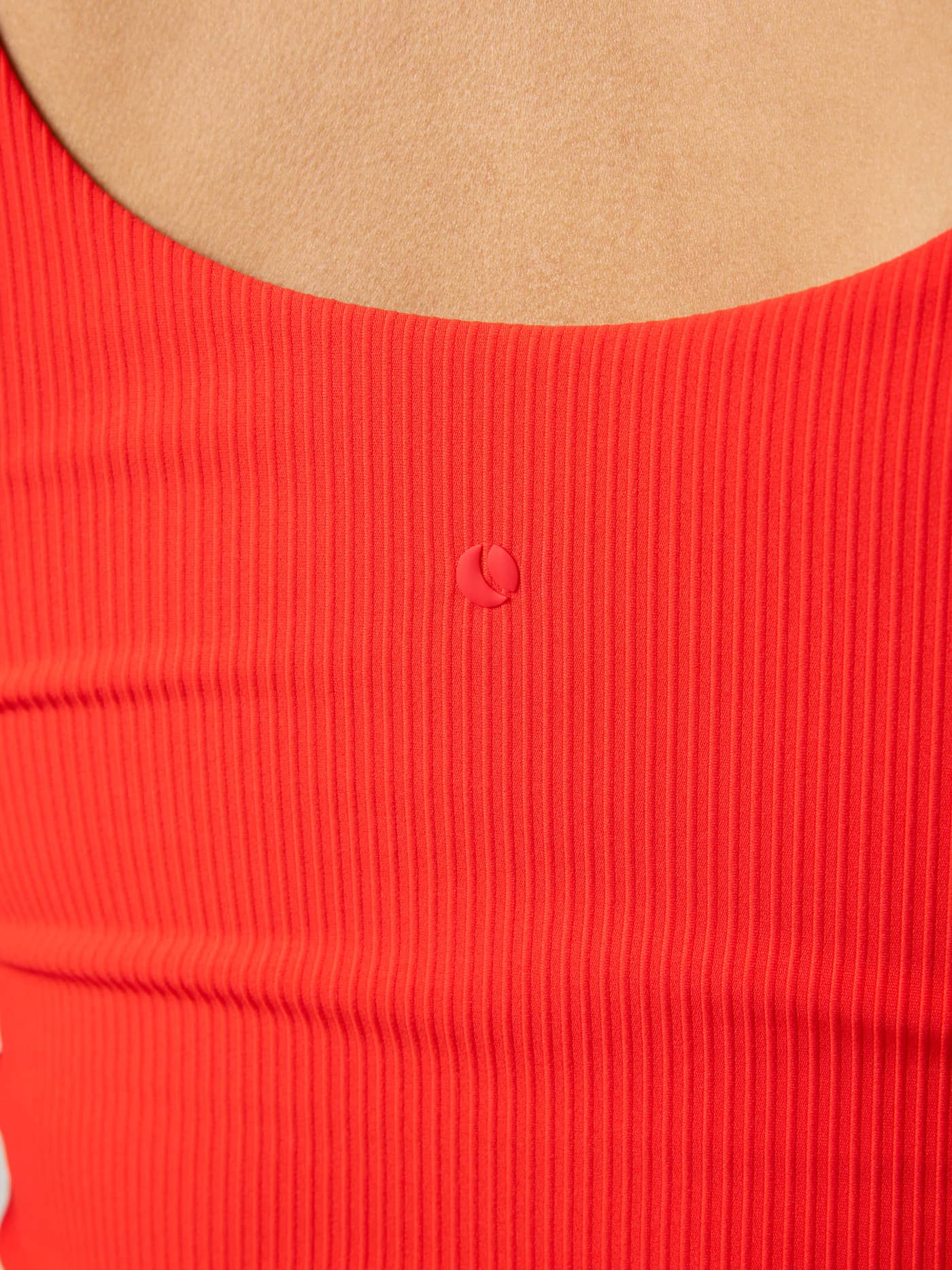 Back neck detail of the Studio Ribbed V-Neck Top in Flame Scarlet (Red) for training, featuring a red tennis logo. - Image 5