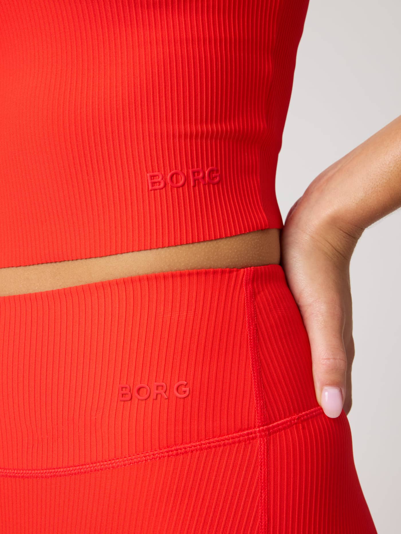 Studio Ribbed V-Neck Top in Flame Scarlet (Red) featuring a ribbed texture and red BORG logo for a premium training look. - Image 6