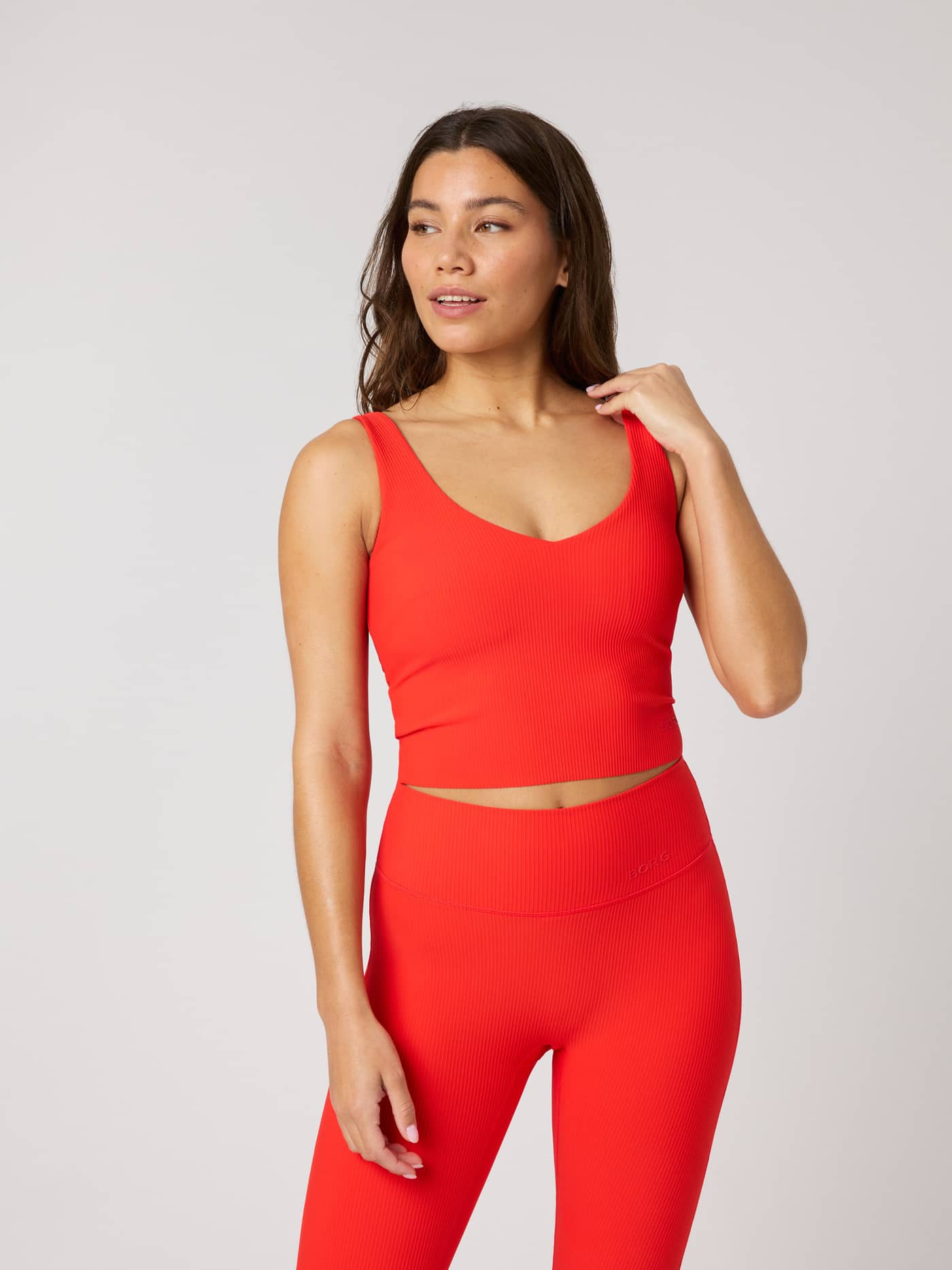 Front view of the Studio Ribbed V-Neck Top in Flame Scarlet (Red) featuring a ribbed texture and tonal logo for training. - Image 2