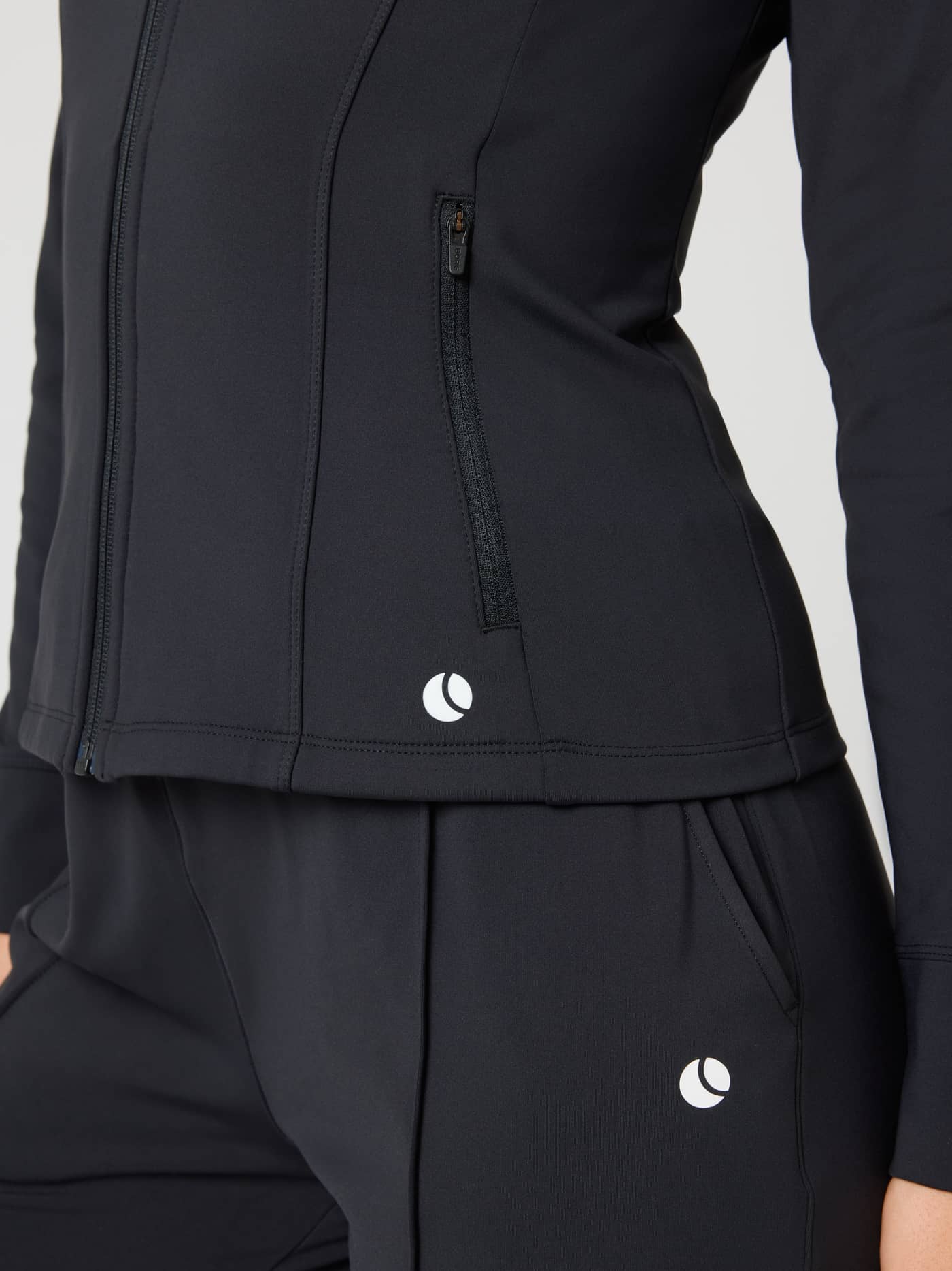 Ace Track Jacket in Black Beauty (Black) featuring a side zip pocket and white tennis ball logo for tennis court play. - Image 4