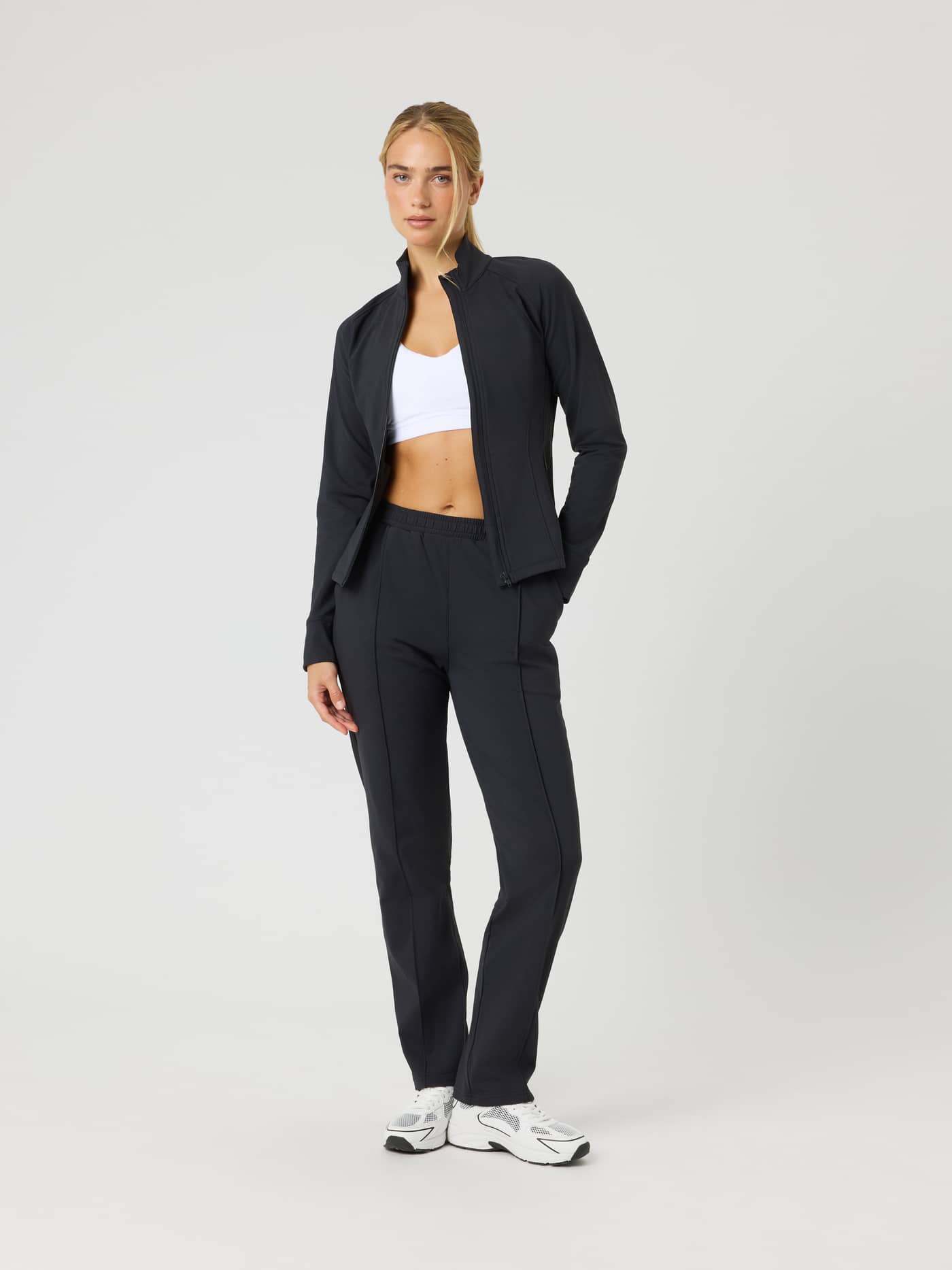 Full-body front view of a model wearing the Ace Track Jacket in Black Beauty (Black) for a premium tennis style. - Image 3