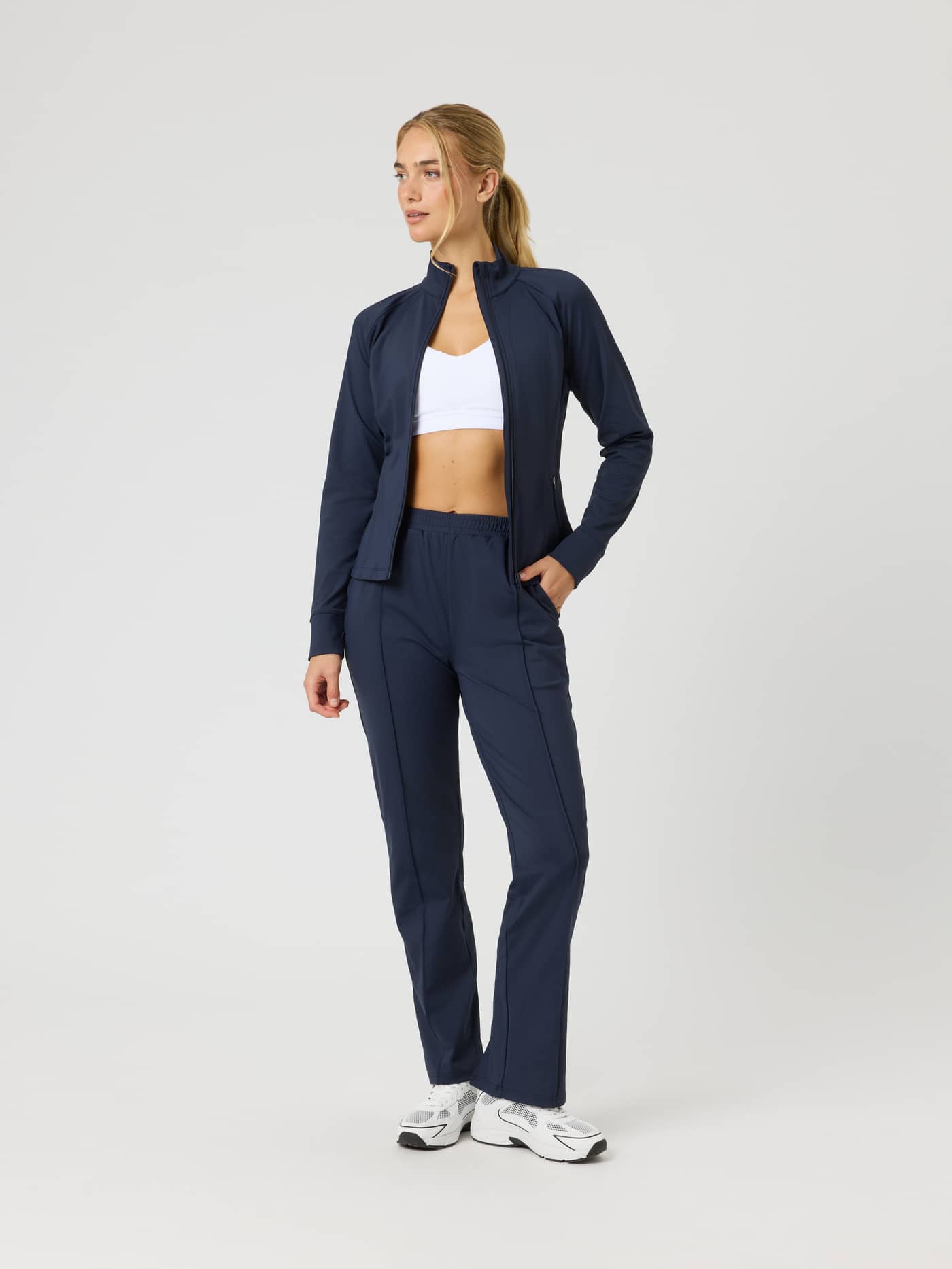 Full-body front view of a model wearing the Ace Track Jacket in Night sky (Navy) for a premium tennis training look. - Image 3