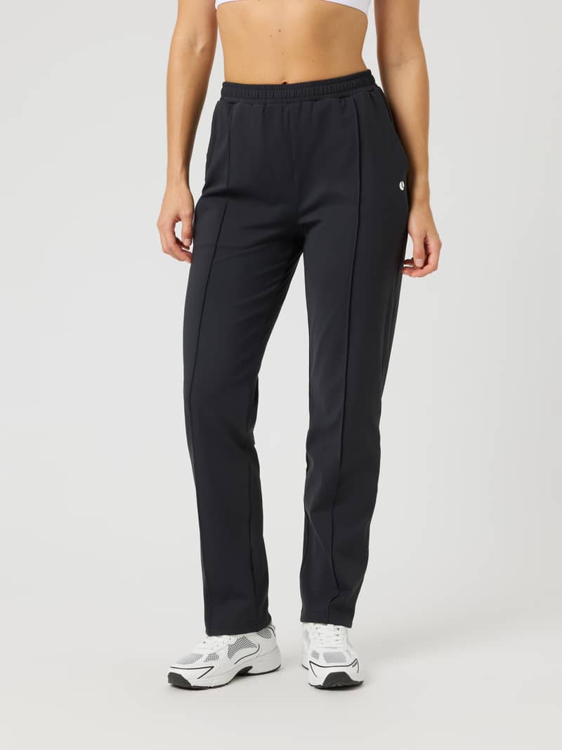 Front view of the Ace Track Pants in Black Beauty (Black) for tennis, featuring a regular fit and small white logo.