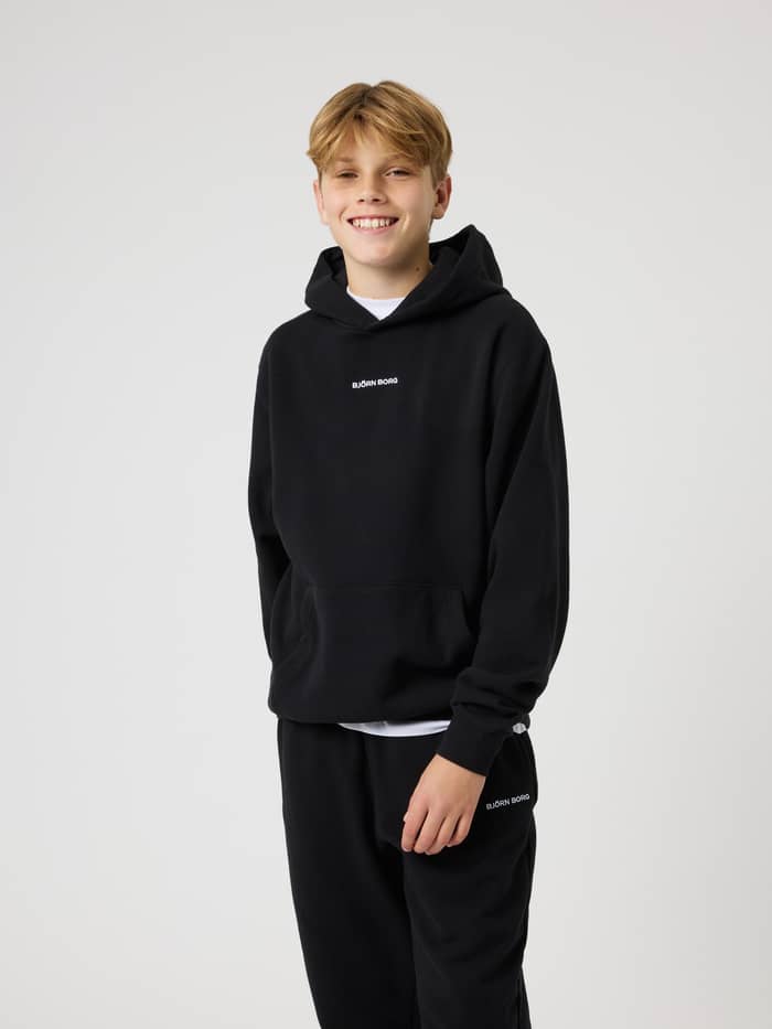 Front view of a kid wearing the Borg Classic Hoodie in Black Beauty (Black) with a white embroidered chest logo.