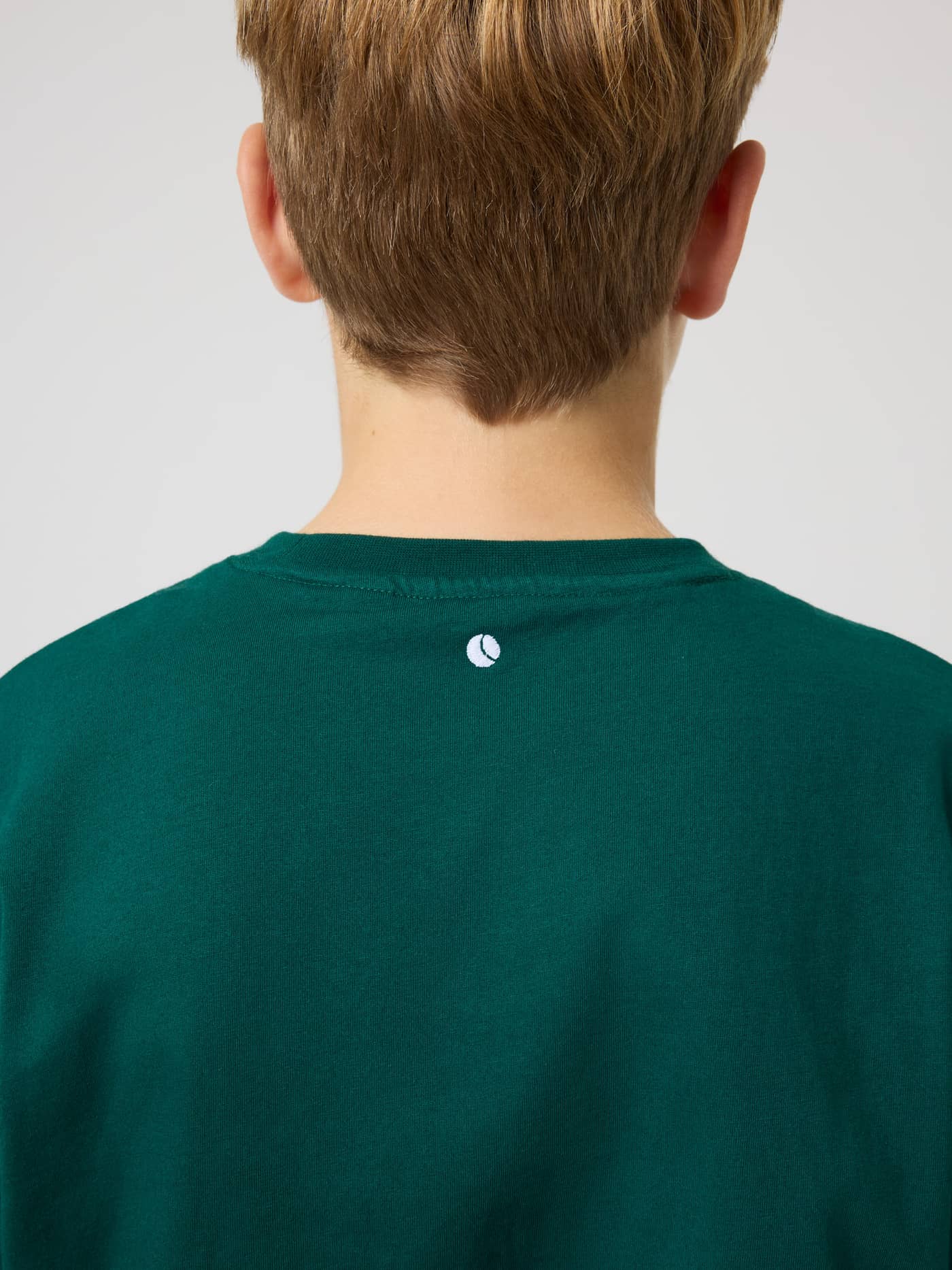 Back neck detail of the kids Borg Classic T-Shirt in Rain Forest (Green) featuring a white tennis ball print. - Image 4