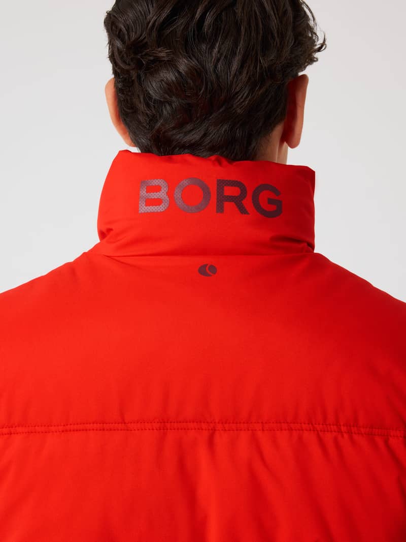 Close-up back view of the padded Borg Puffer Jacket in Flame Scarlet (Red) with a black collar logo and tennis ball print. - Image 5