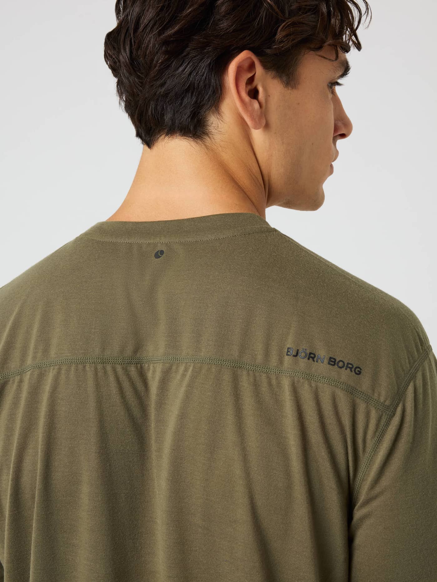 Back view of the Borg Soft Sports T-Shirt in Kalamata (Green) with a black logo and tennis ball print for training. - Image 4