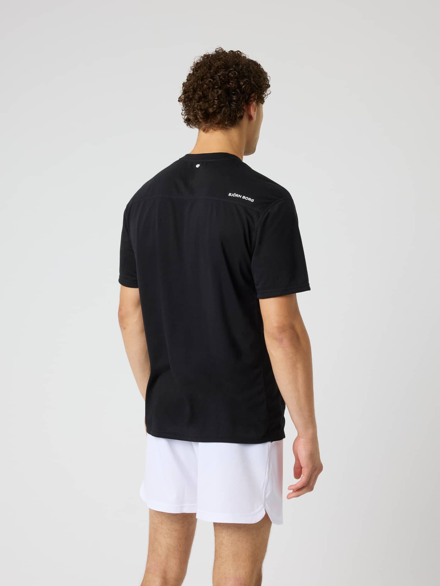Back view of the Borg Soft Sports T-Shirt in Black Beauty (Black), a technical training tee with a tennis print. - Image 3