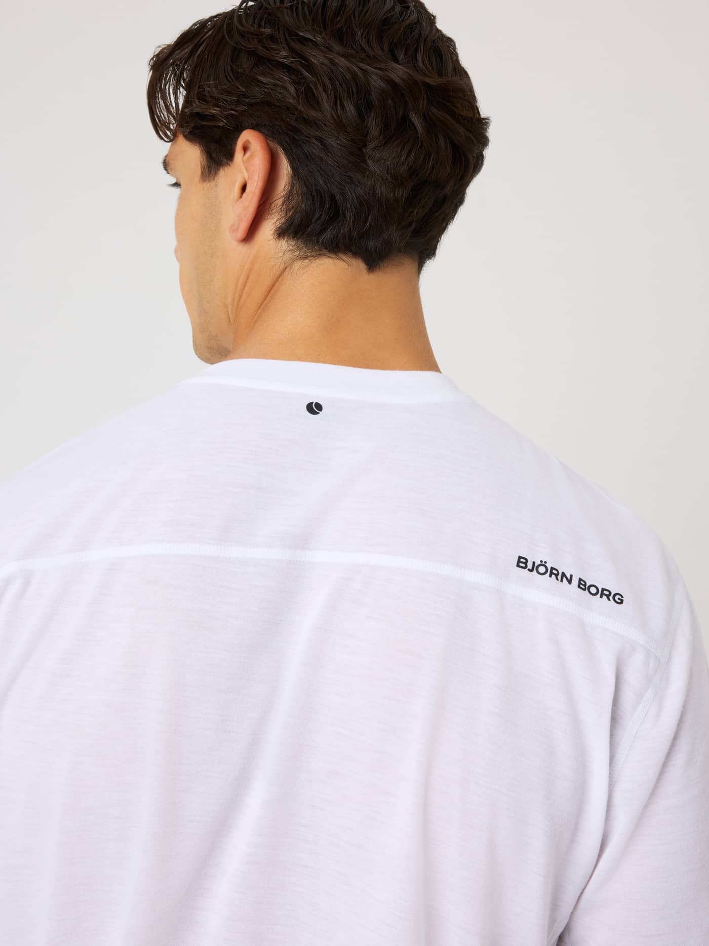 Back view of the Borg Soft Sports T-Shirt in Brilliant White (White) featuring black logos for training and tennis. - Image 4