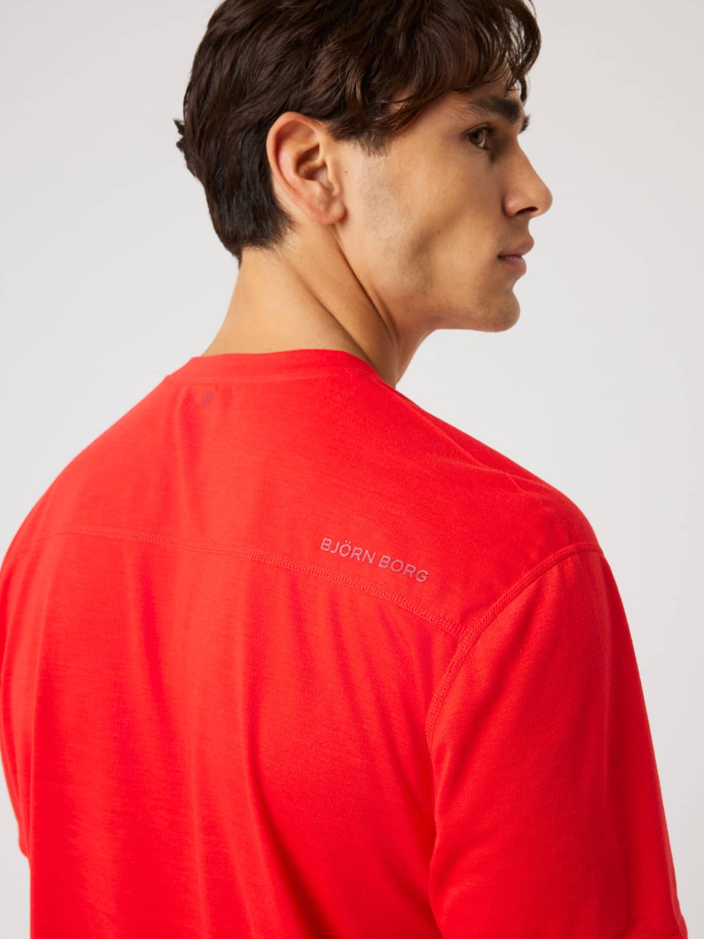 Close-up back view of the Borg Soft Sports T-Shirt in Flame Scarlet (Red) with a silver logo for training and tennis. - Image 4
