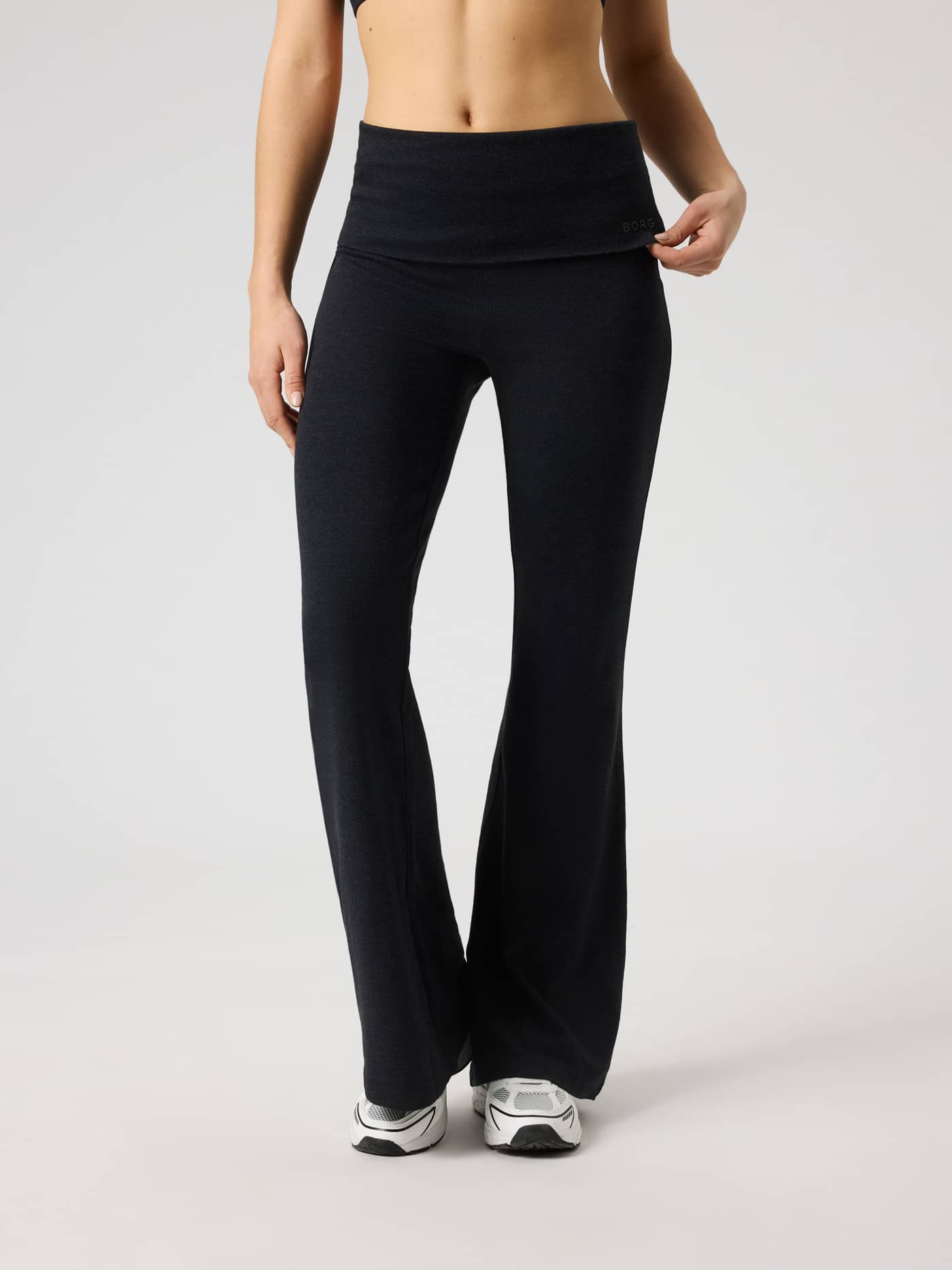 Front view of Studio Flow Folded Flare Tights in Black Beauty (Black) with a folded waistband and black logo for training. - Image 2