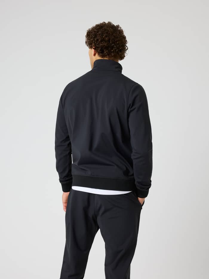 Back view of a man wearing the Ace Court Jacket in Black Beauty (Black), a technical tennis jacket with a regular fit. - Image 2