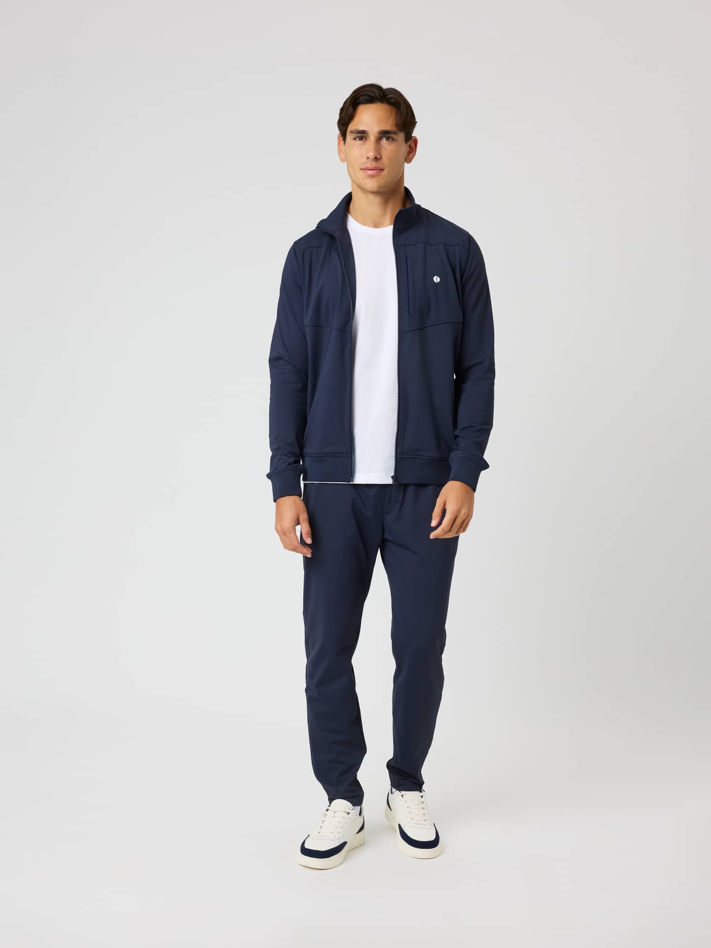 Full-body front view of the Ace Court Jacket in Night Sky (Navy) with a white tennis ball logo for tennis warm-ups. - Image 3