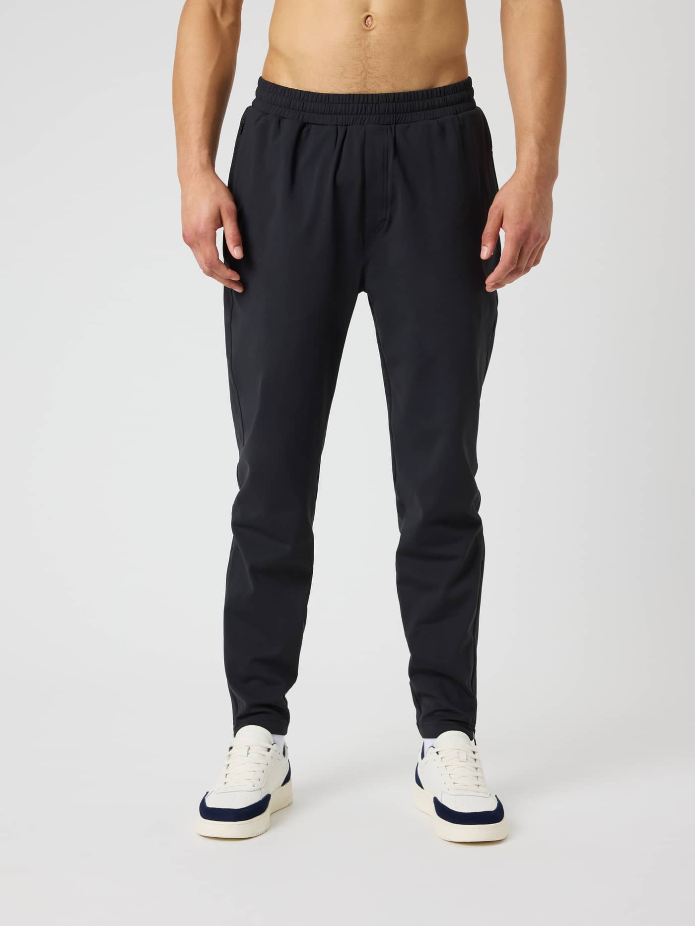 Front view of a model wearing Ace Court Pants in Black Beauty (Black), premium tennis pants with a regular fit. - Image 1