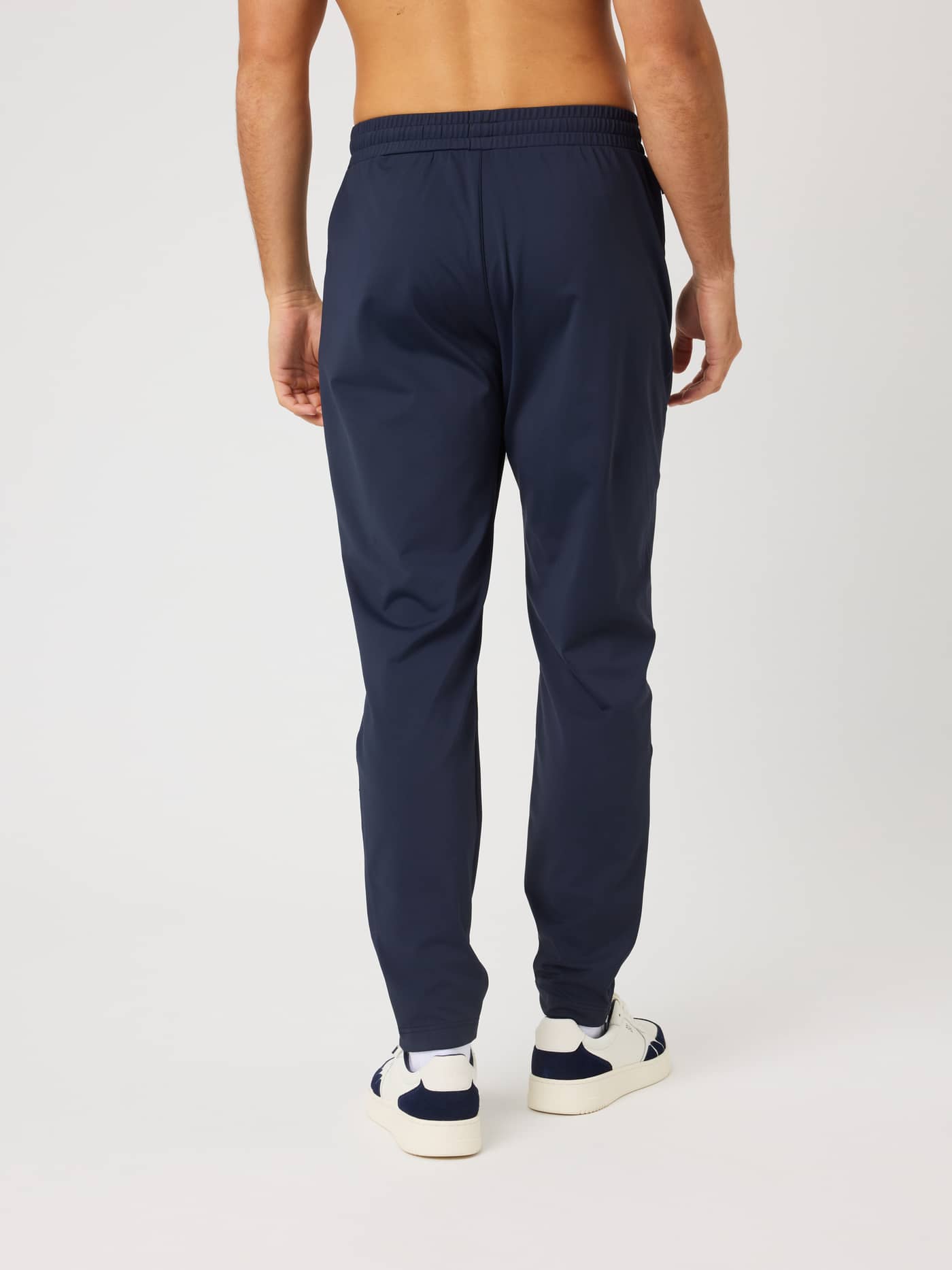 Back view of a model wearing Ace Court Pants in Night Sky (Navy), technical track pants for tennis and training. - Image 2