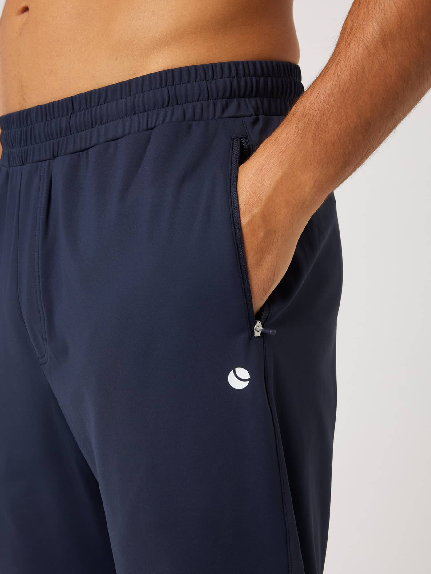 Close-up of Björn Borg Ace Court Pants in Night Sky (Navy) featuring a zip pocket and white logo for tennis training. - Image 4