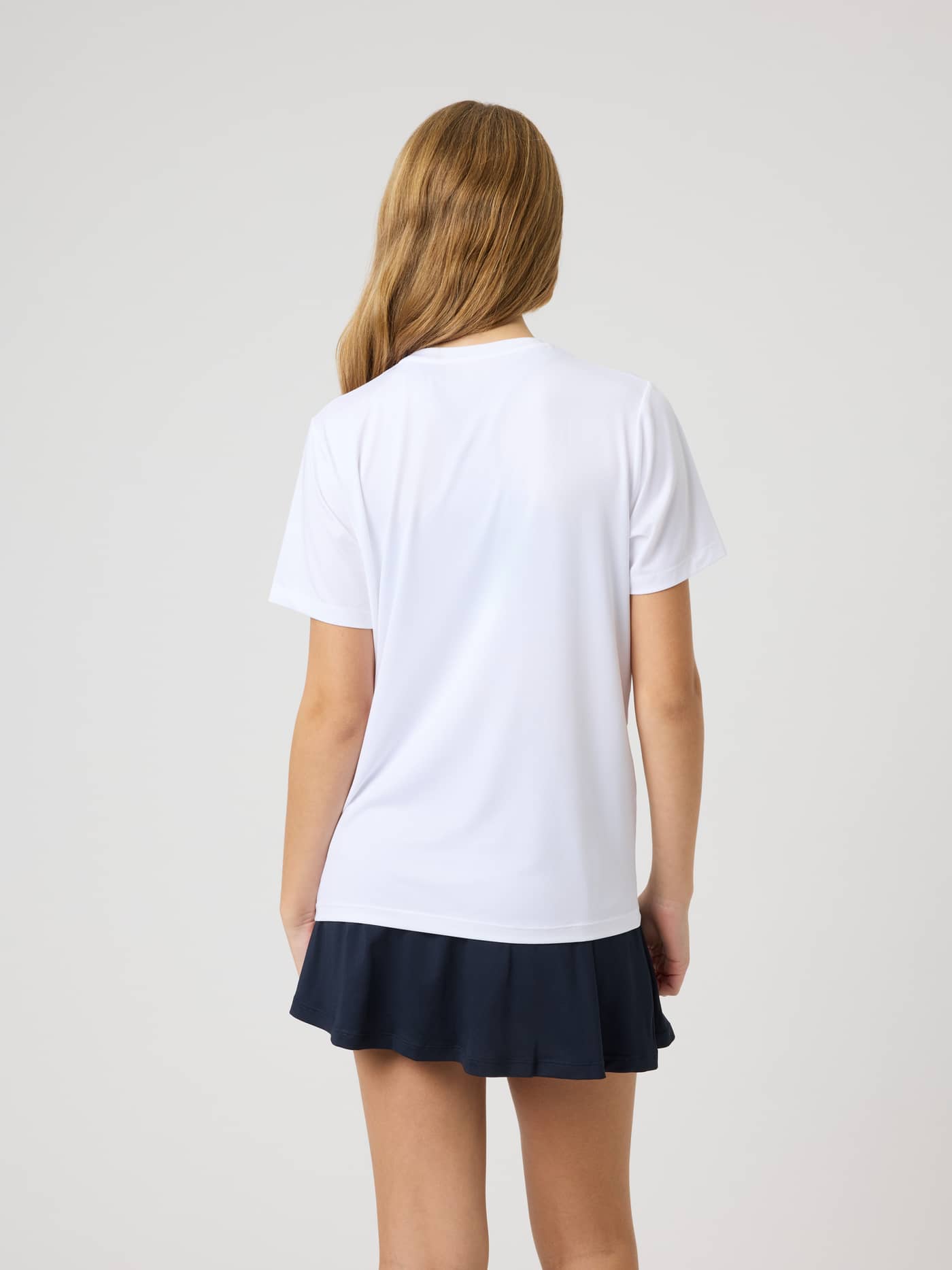 Back view of the Ace Slim T-Shirt in Brilliant White (White), a performance tennis top for kids with a slim fit. - Image 2