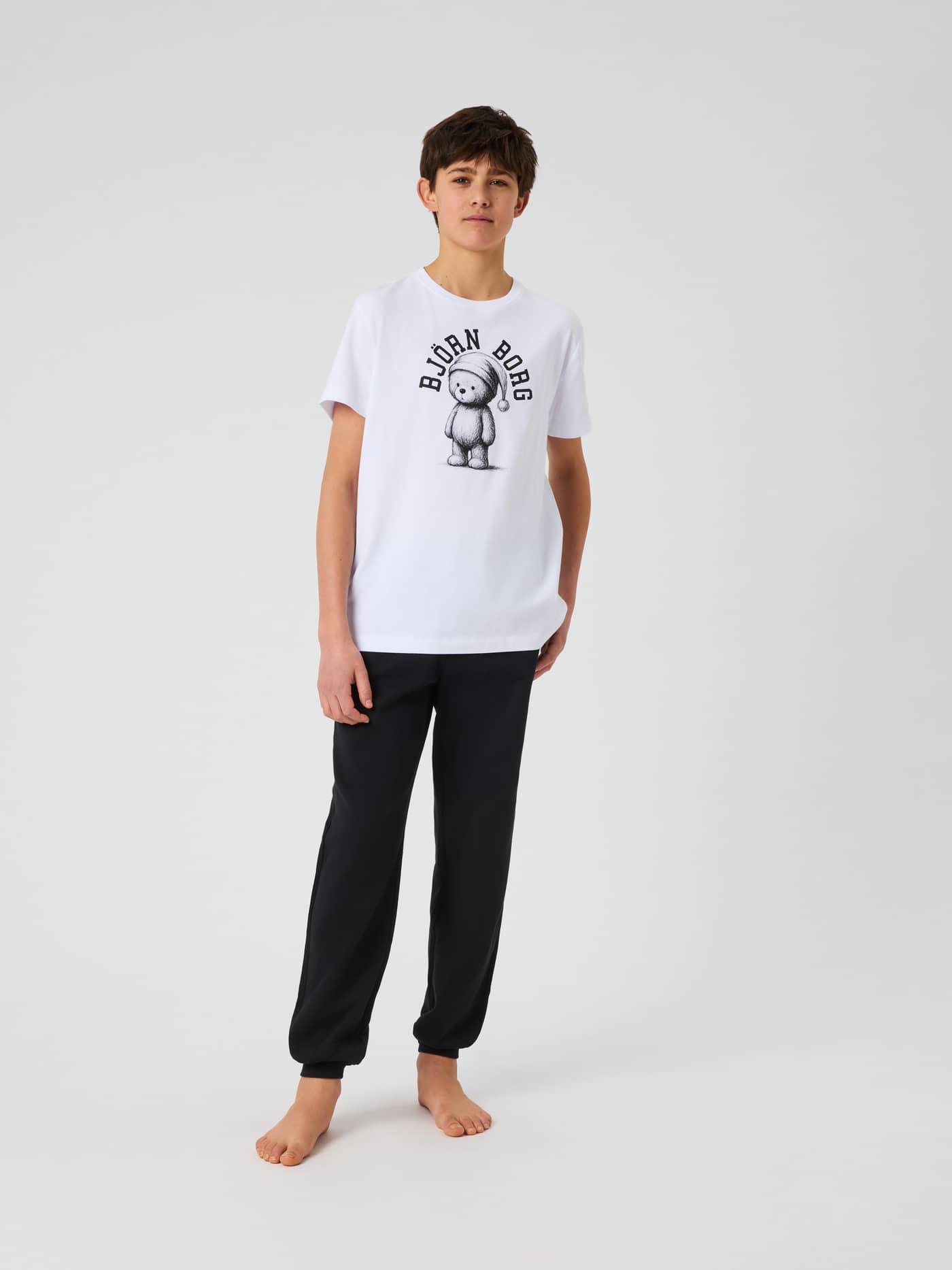 Full-body front view of a model wearing kids Björn Borg Core Loungewear Pants in Black Beauty (Black) for a relaxed look. - Image 3