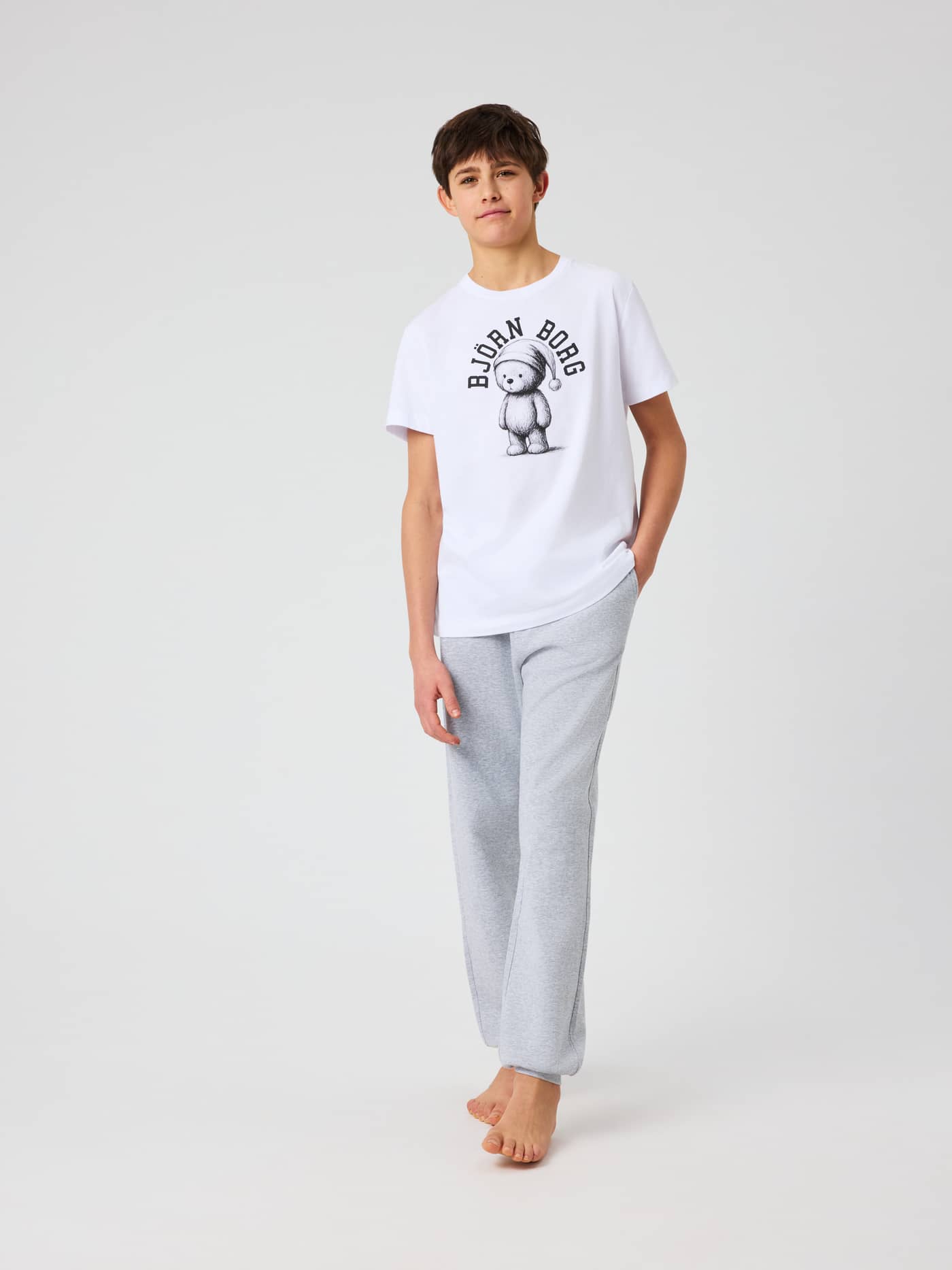 Full-body front view of kids in Core Loungewear Pants in Light Grey Melange (Grey) with melange texture and logo waistband. - Image 3
