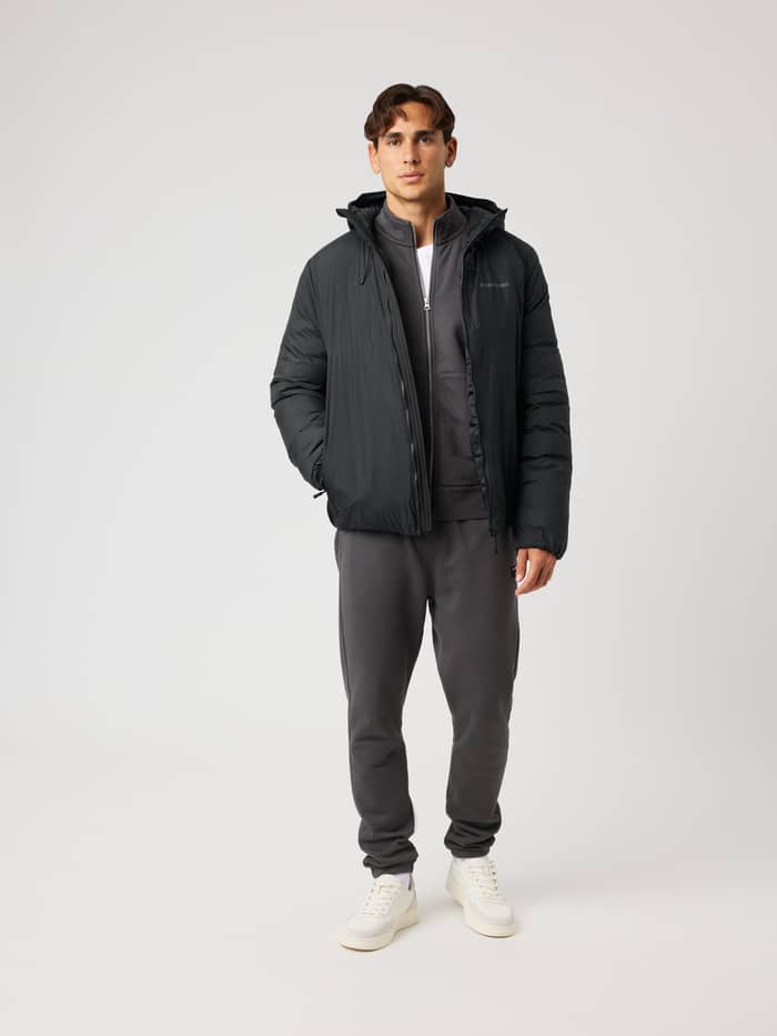 Front view of a model wearing the padded Borg Liner Hood Jacket in Black Beauty (Black) for training and everyday movement. - Image 4