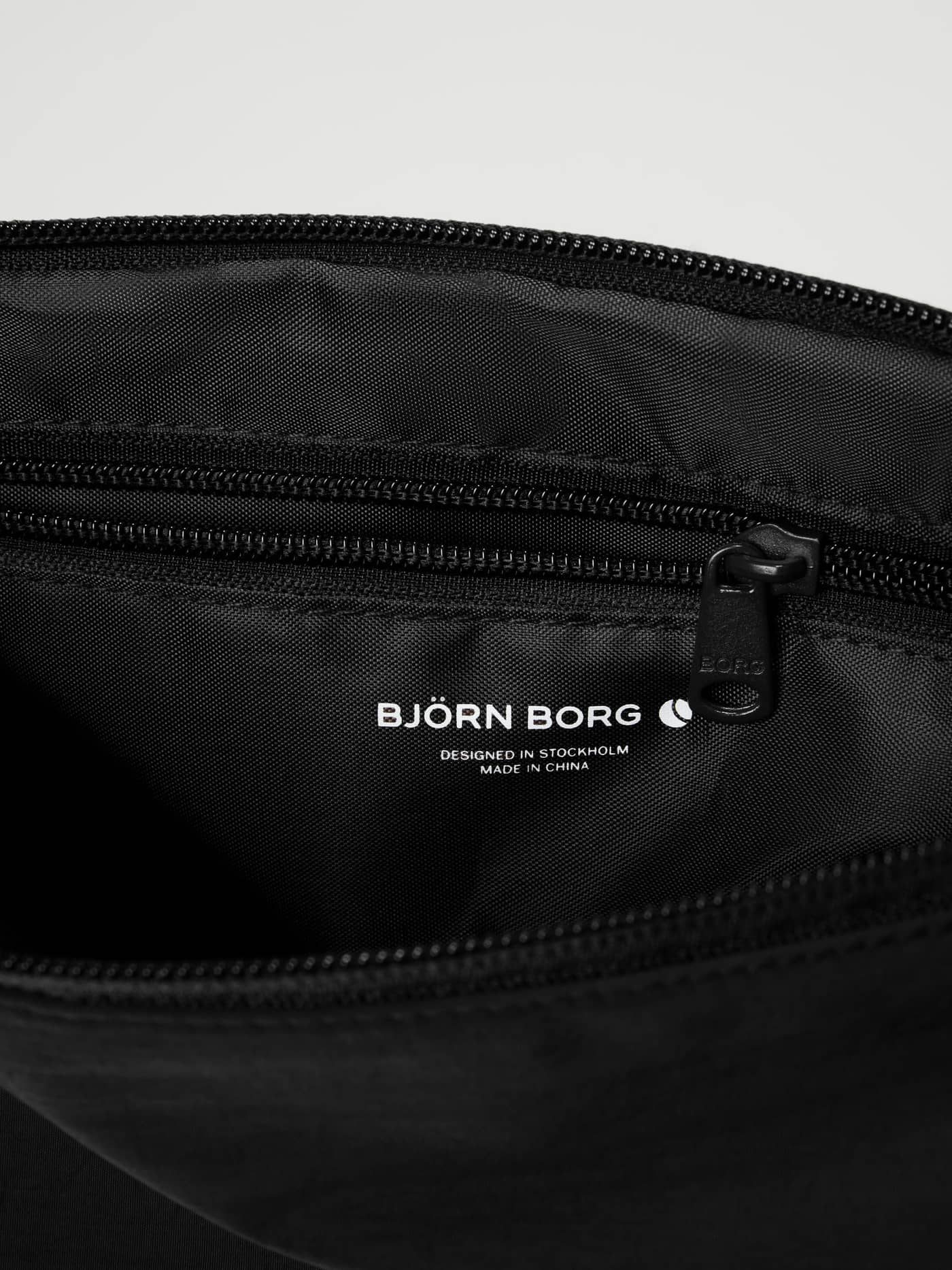 Interior view of the Studio Active Wash Bag Set in Black Beauty (Black) showing the zip pocket and white logo for training. - Image 4