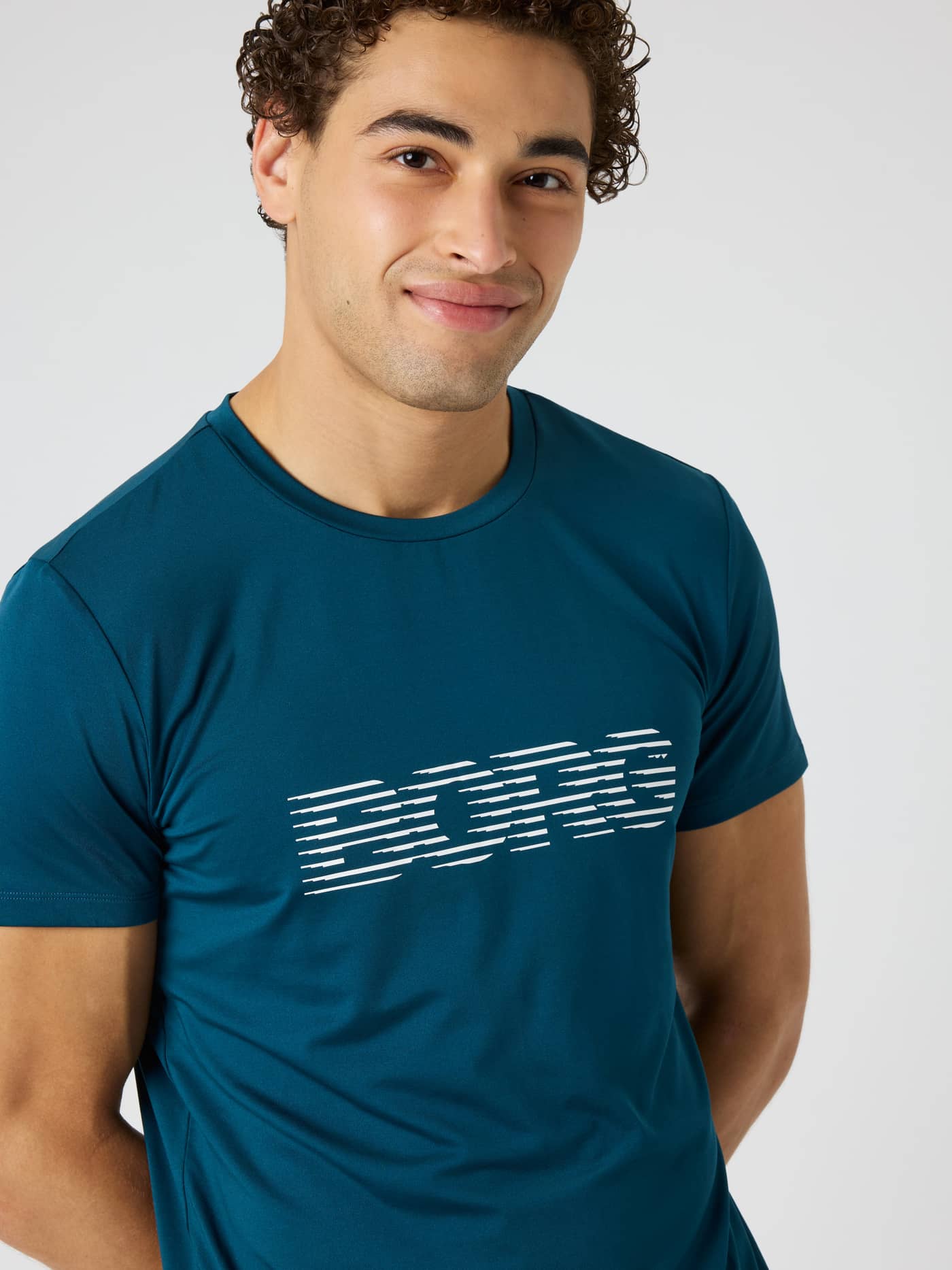 Close-up of the Borg Graphic T-Shirt in Reflecting Pond (Green) with a white chest logo for training and tennis. - Image 4