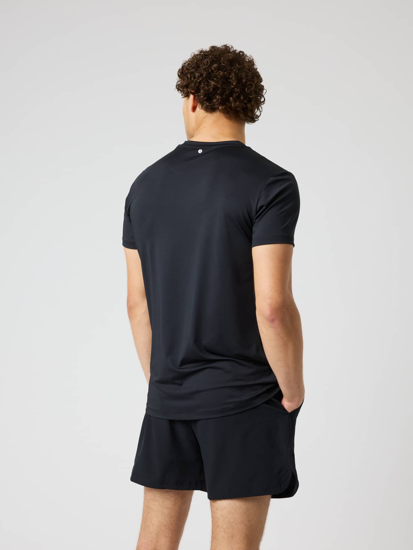 Back view of the Borg Graphic T-Shirt in Black Beauty (Black) for training and tennis with a small white back neck logo. - Image 3