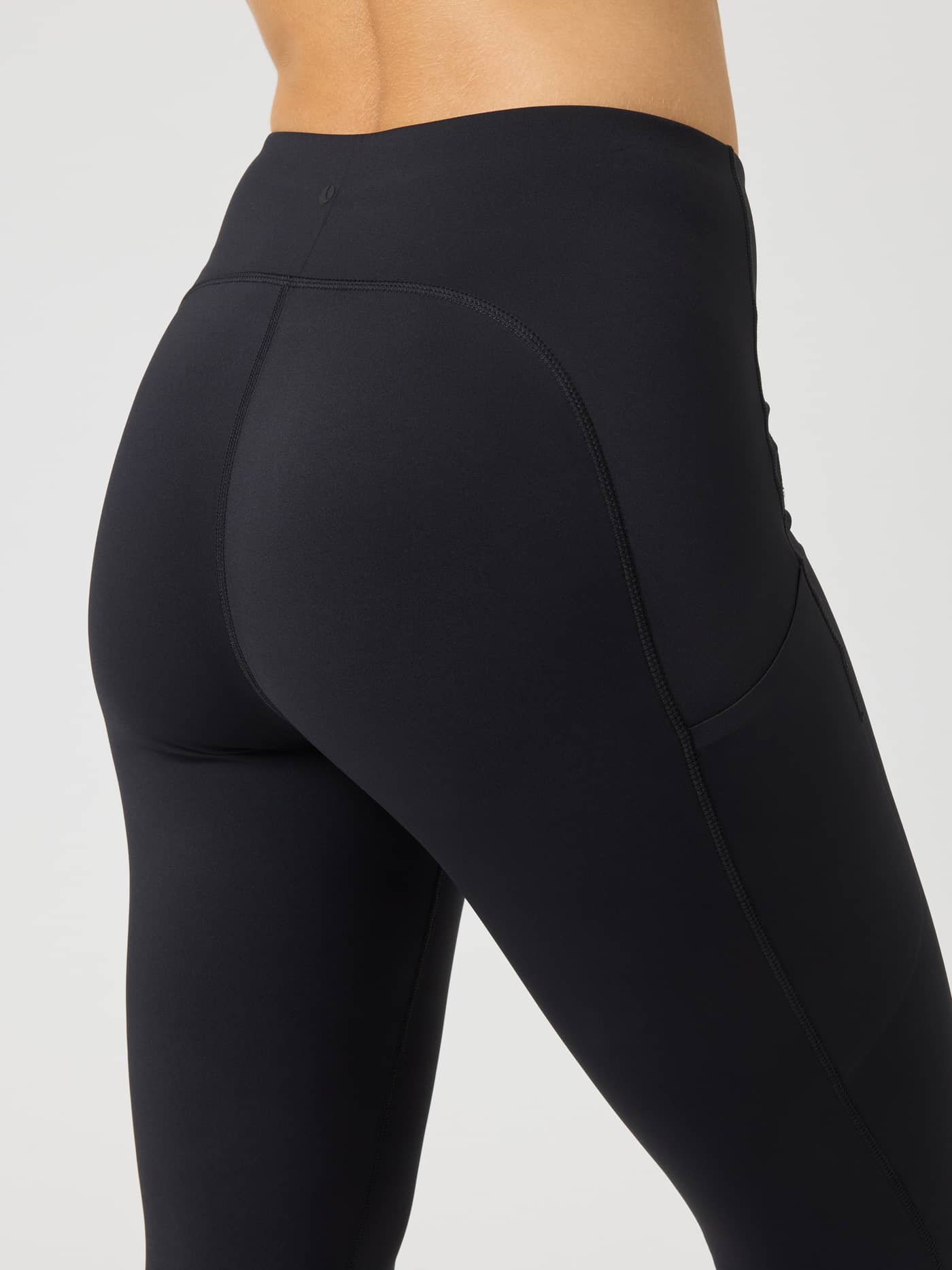 Back view of the Borg Reform Pocket Tights in Black Beauty (Black) with side pockets and a tennis ball print for training. - Image 4