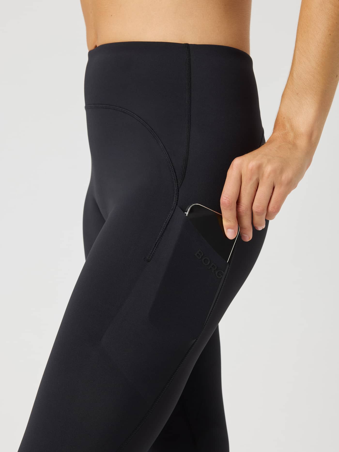 Side view of Borg Reform Pocket Tights in Black Beauty (Black) highlighting the functional side pocket for training. - Image 5