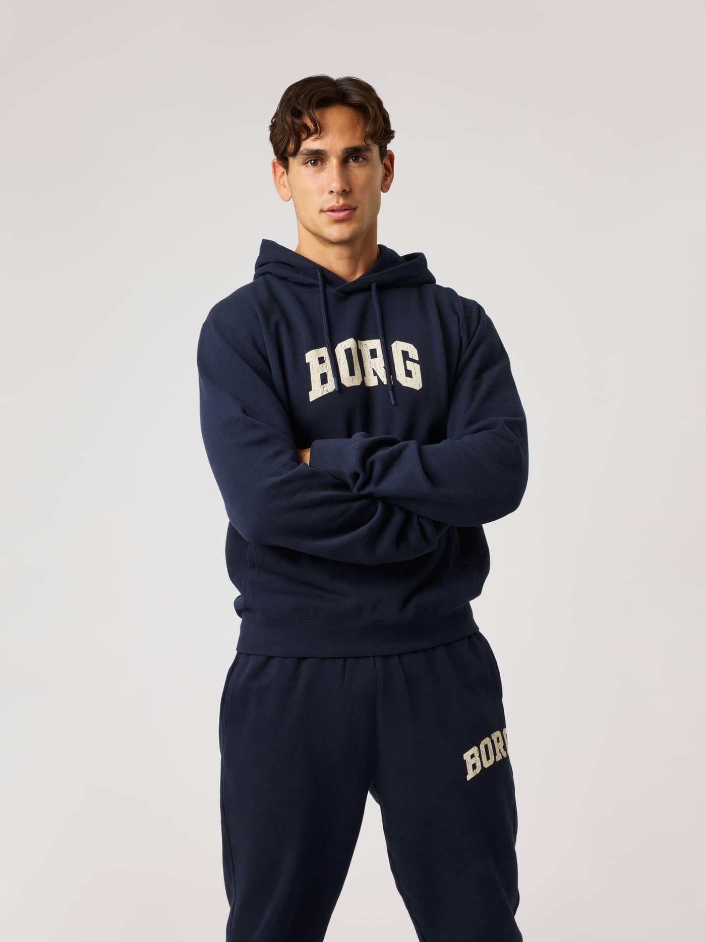 Front view of the Borg Classic Print Hoodie in Night sky (Navy) with an off-white logo, ideal for training and recovery. - Image 2