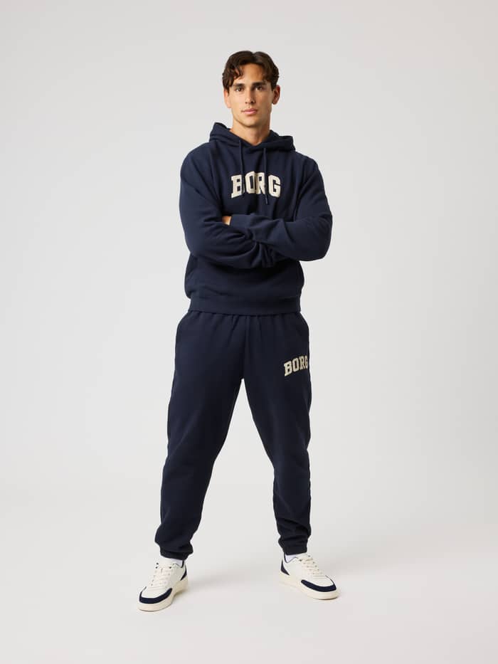 Full-body front view of a model in the cotton Borg Classic Print Hoodie in Night Sky (Navy) for training and recovery. - Image 4