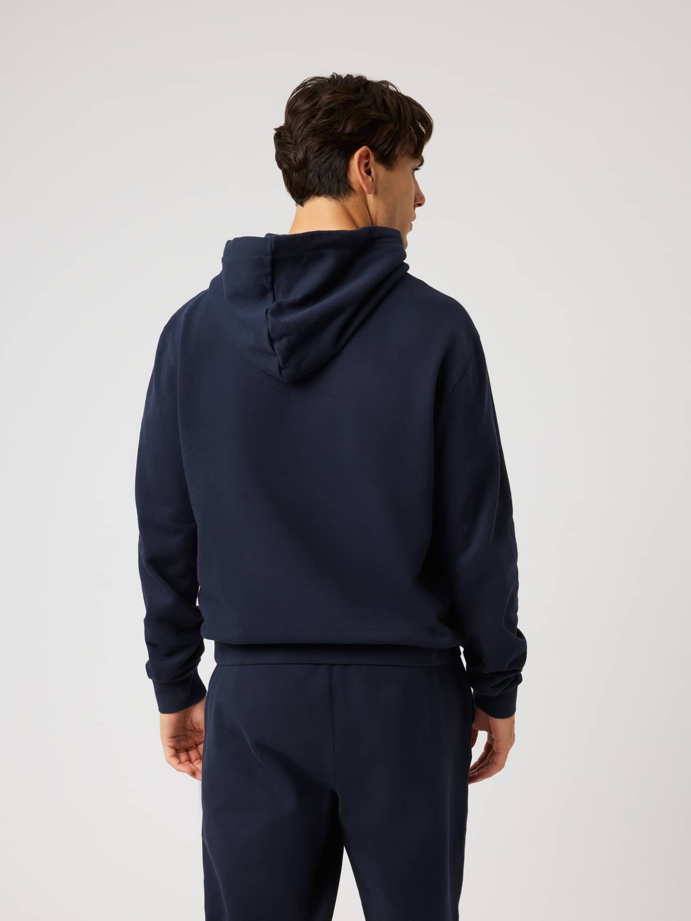 Back view of a model in the Borg Classic Print Hoodie in Night sky (Navy), a cotton training layer with a regular fit. - Image 3