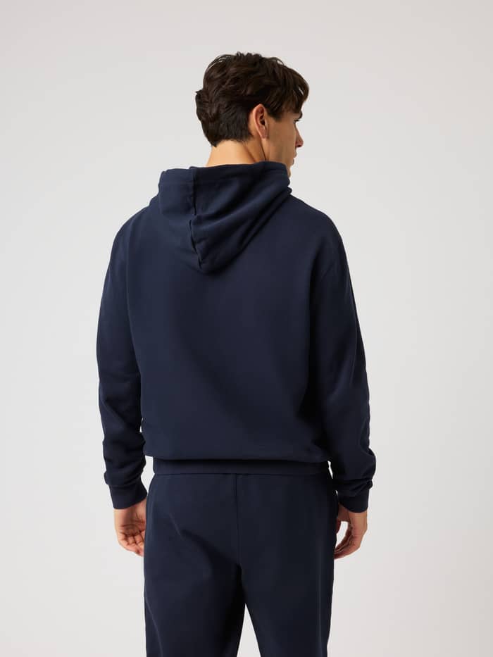 Back view of a model in the Borg Classic Print Hoodie in Night sky (Navy), a cotton training layer with a regular fit. - Image 3