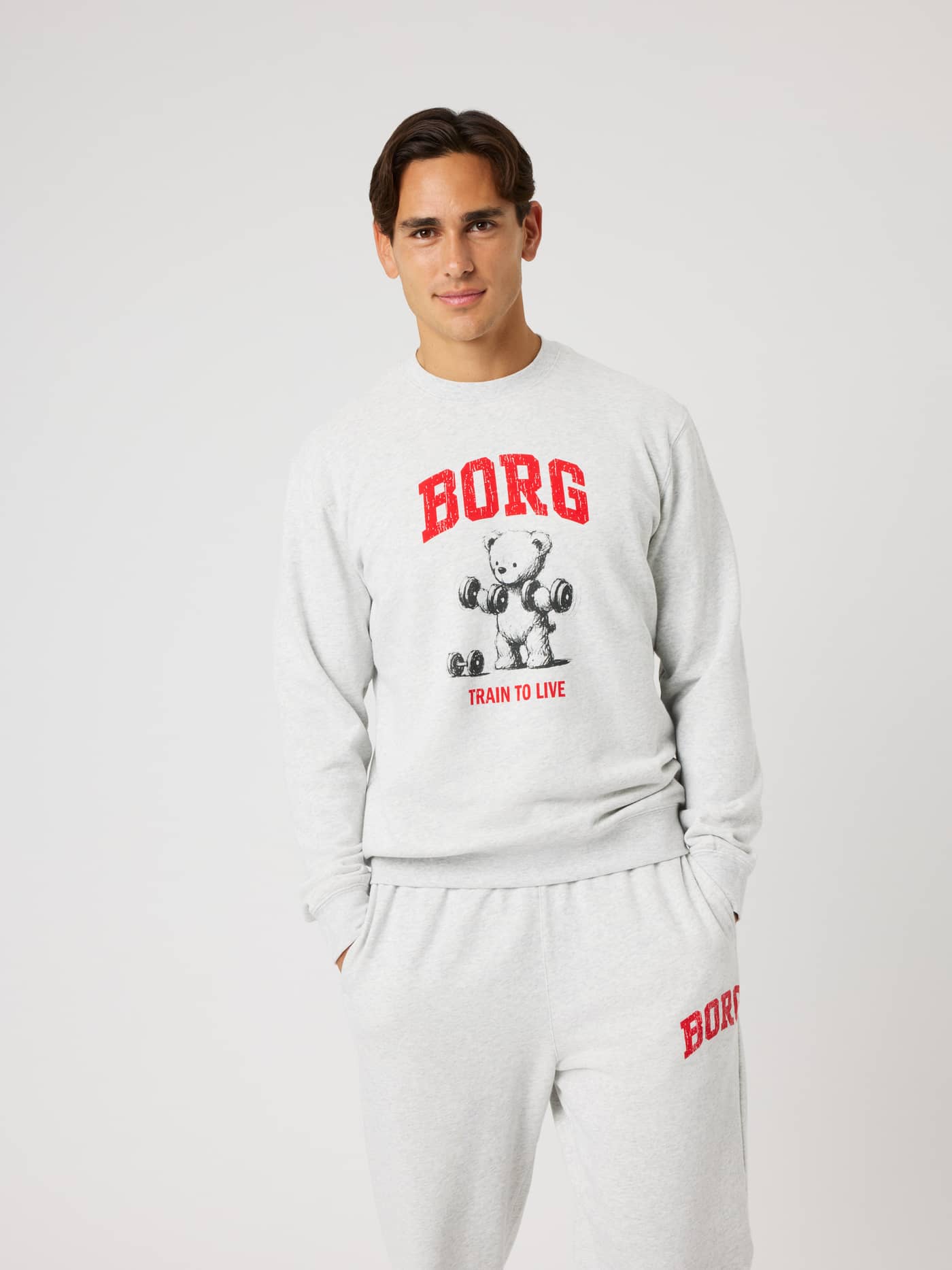 Vue de face d'un modèle en Borg Classic Print Sweatshirt Ultra Light Grey Melange (Gris) avec graphique de training rouge. - Image 1