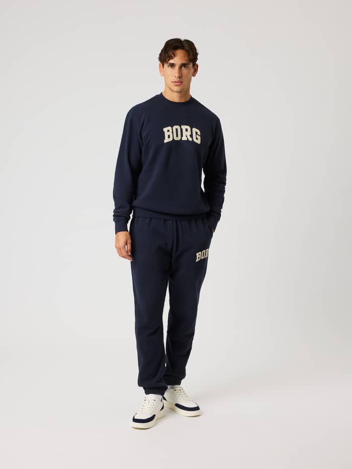 Full-body front view of the Borg Classic Print Sweatshirt in Night sky (Navy) with a cream logo and tennis-inspired style. - Image 3