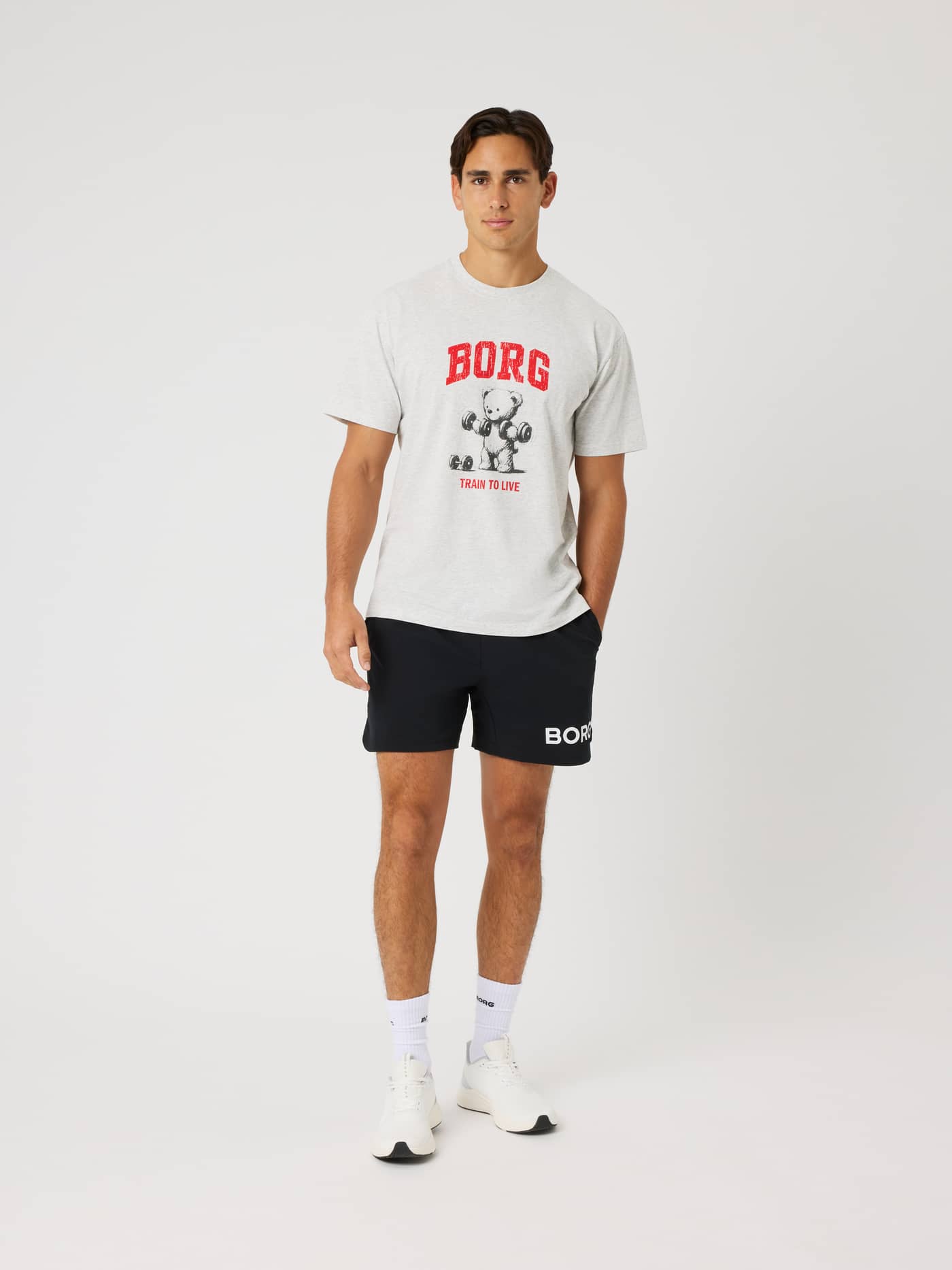 Full-body front view of a model wearing the Borg Classic Print T-Shirt in Ultra Light Grey Melange (Grey) for training. - Image 2
