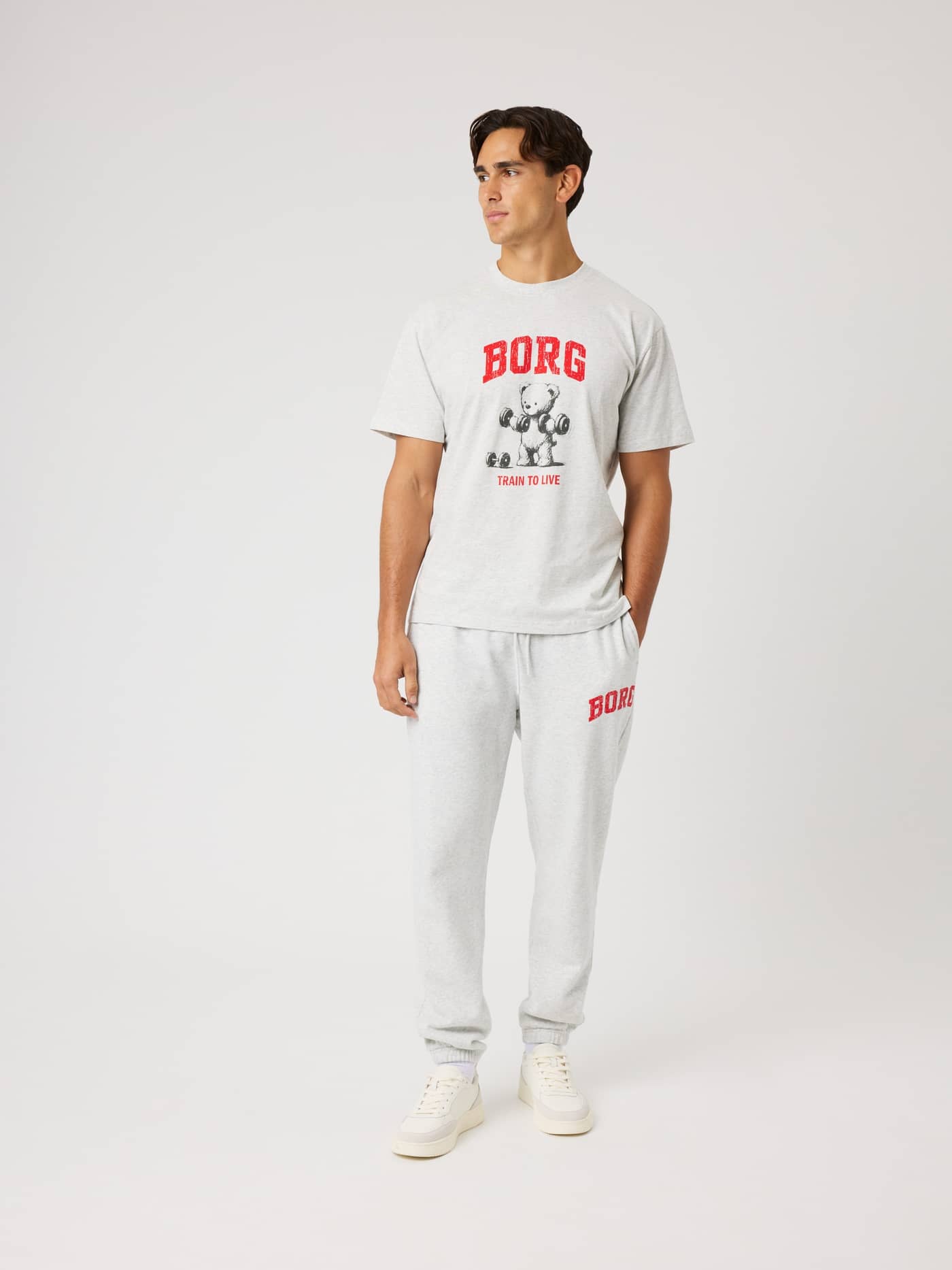 Borg Classic Print Sweatpants in Ultra Light Grey Melange (Grey) on a model with a red logo, ideal for training. - Image 3