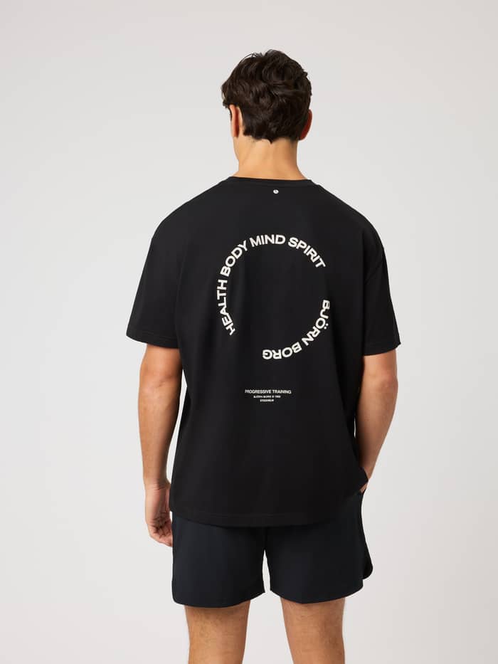 Back view of the Borg Gym Oversized T-Shirt in Black Beauty (Black) with white training graphics and tennis ball detail.
