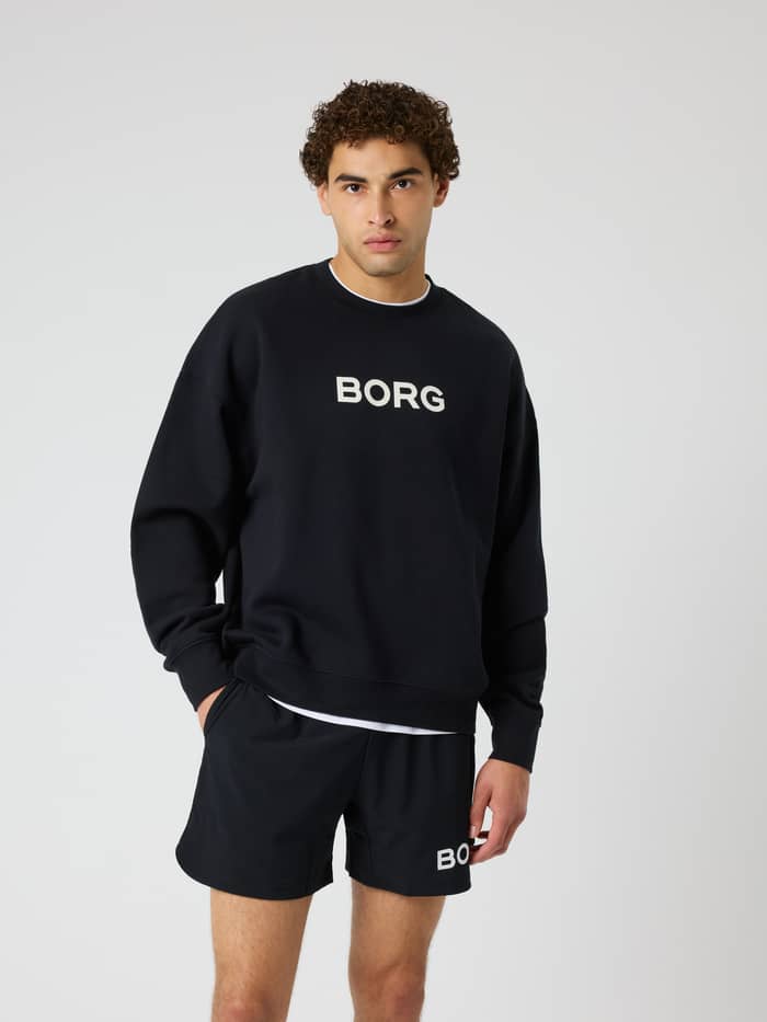 Front view of a model wearing the Borg Oversized Sweatshirt in Black Beauty (Black) for a relaxed training fit.